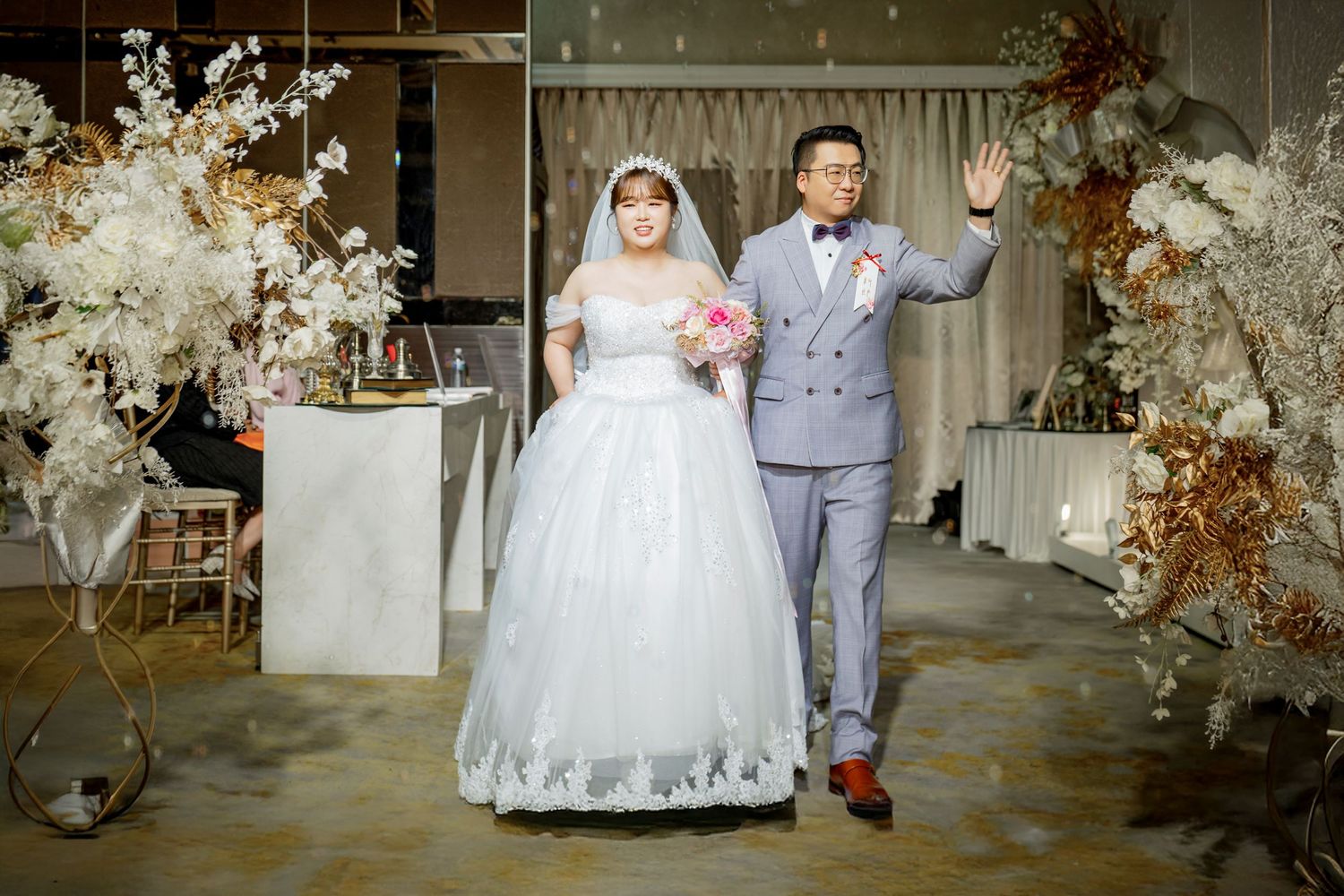 A romantic wedding photo collage showing couples in traditional white gown and gray suit amid elegant floral decorations.