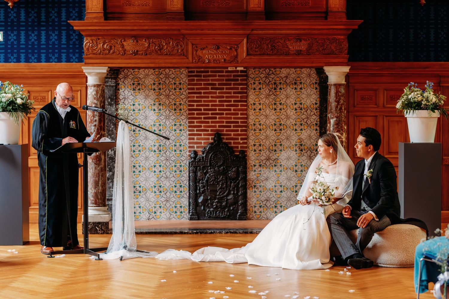 Ceremonie op elegante locatie met bakstenen muren, witte stoelen en bloemdecoraties, bruidsfotografie Noordbrabants Museum Den Bosch, Braban