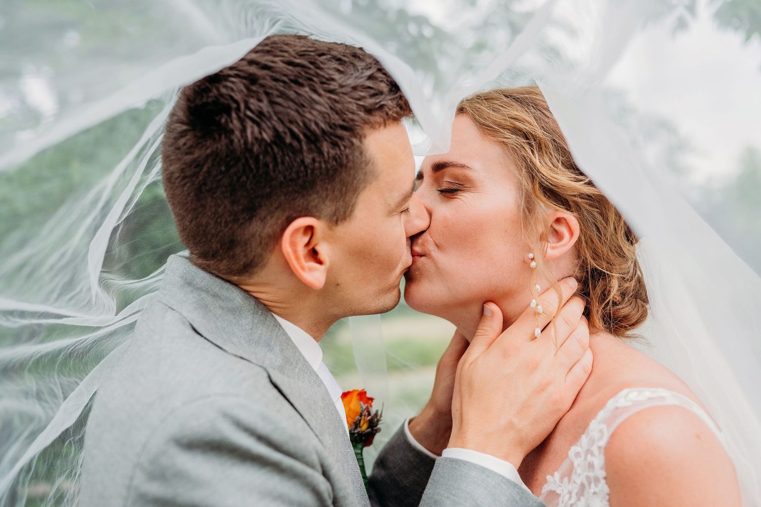 Romantic wedding couple shares intimate kisses in a series of outdoor portraits with natural lighting.