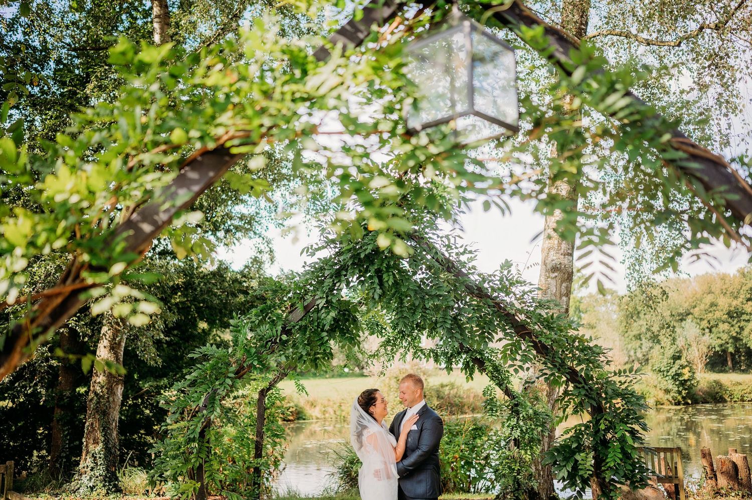 Romantische buitenceremonie onder natuurlijke boog van bomen, bruidsfotografie Kasteel Maurick Vught, Brabant.
