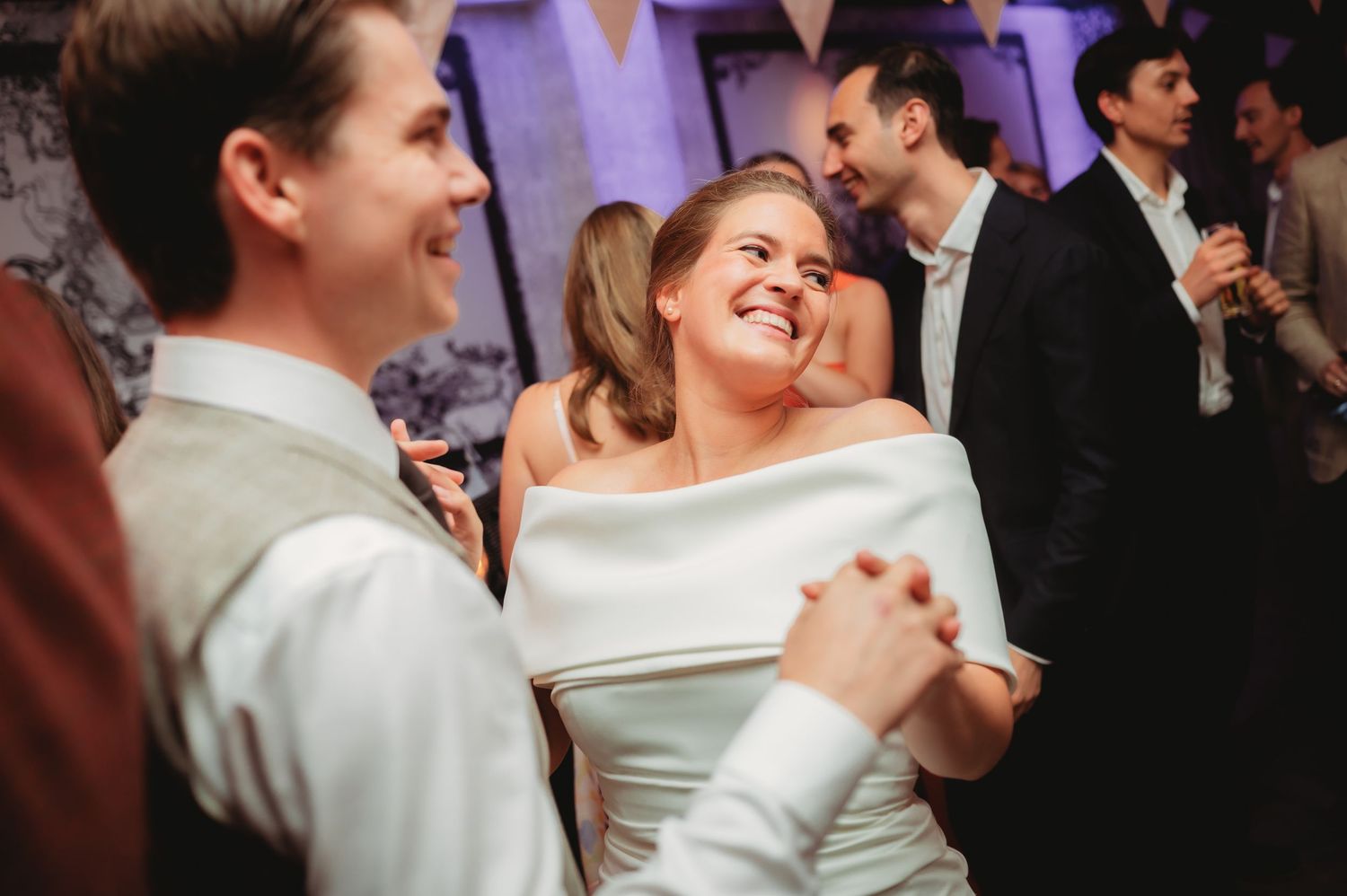 Bride and groom share joyful first dance at elegant wedding reception.
