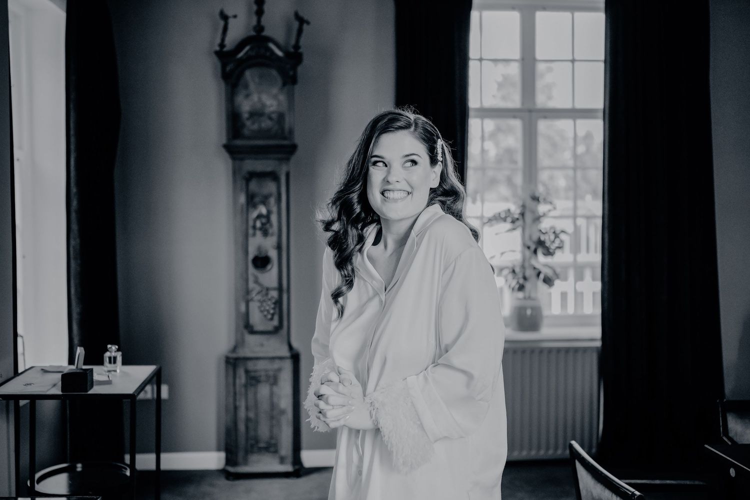 Elegante bridal voorbereidingen in een lichte kamer met klassiek interieur, ideaal voor bruidsfotografie Den Bosch.