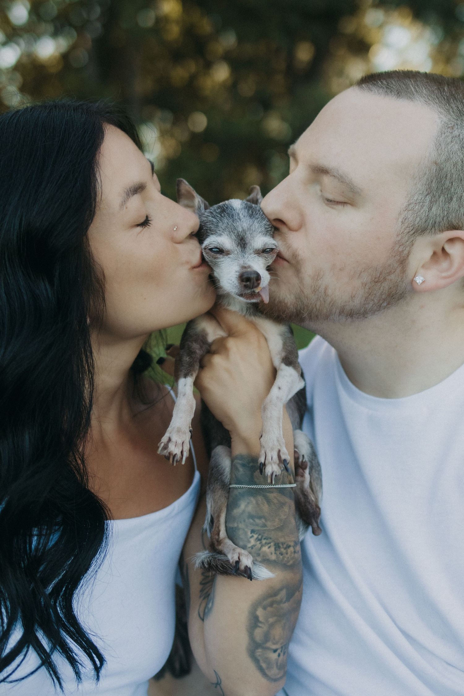 A couple shares kisses with their small gray dog in a series of four sweet, candid photos.