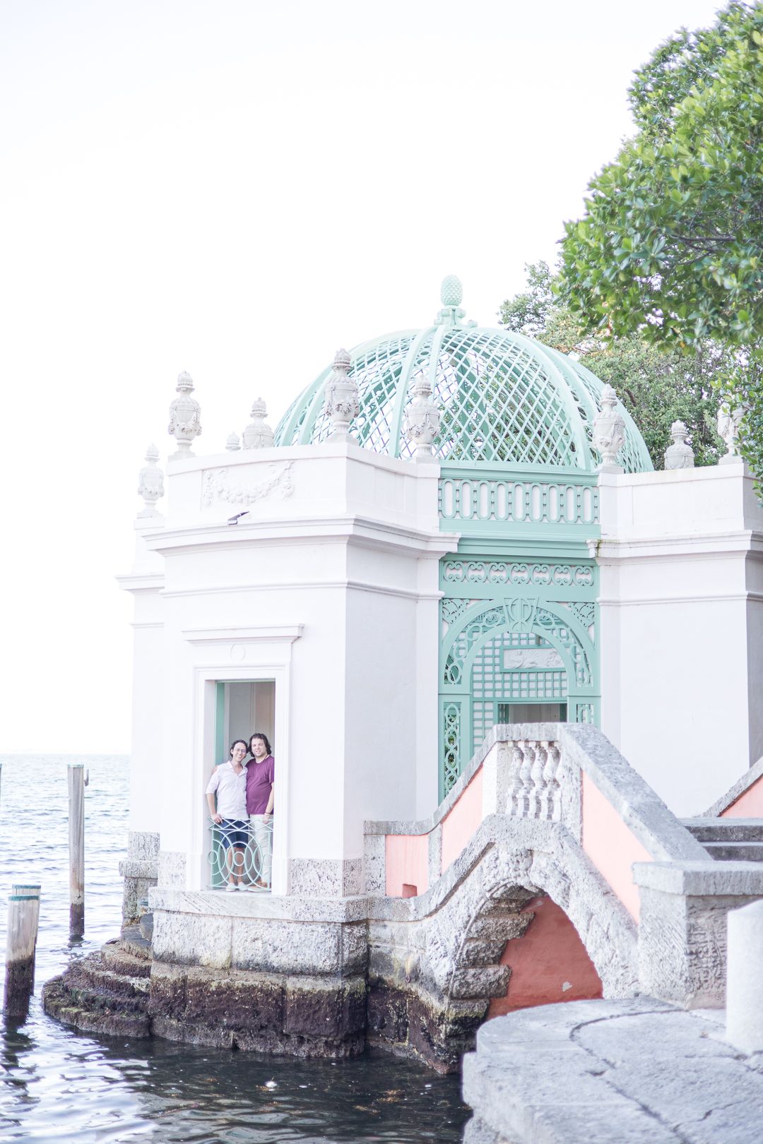 Vintage waterfront pavilion with mint green dome and white architectural details overlooking the water.