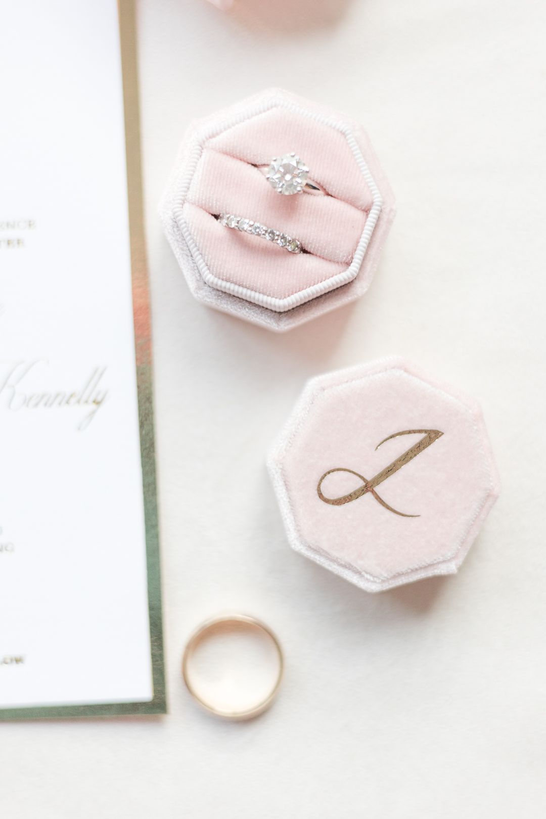 Elegant engagement ring and wedding band in pink velvet hexagonal ring box with monogram.
