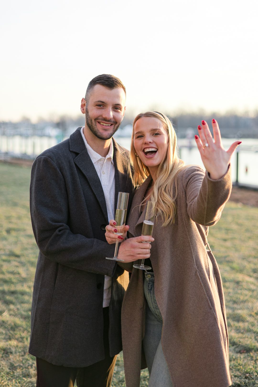 A celebratory moment with champagne glasses and an engagement ring display.