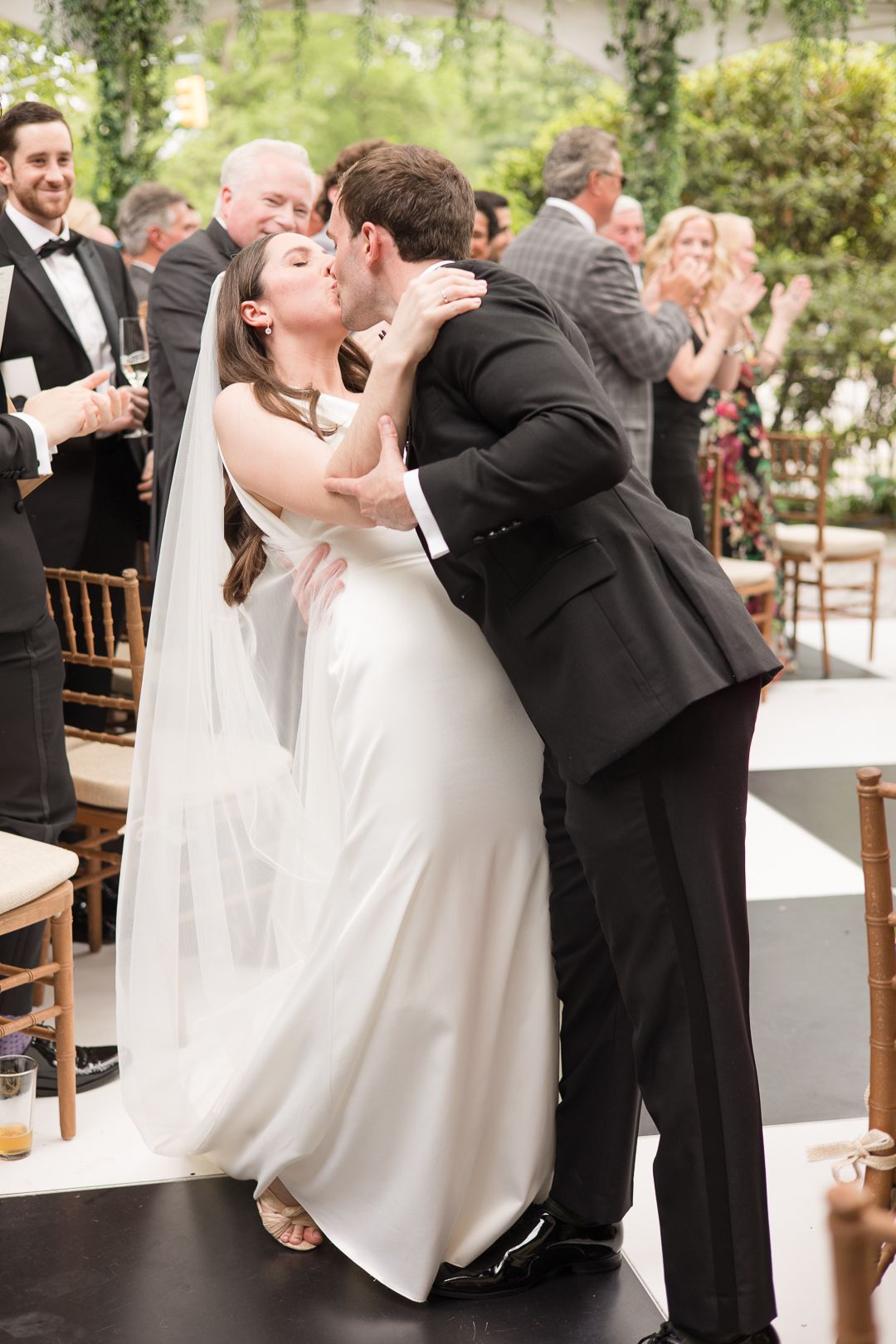 A romantic moment during a wedding reception with the couple sharing their first dance surrounded by guests.