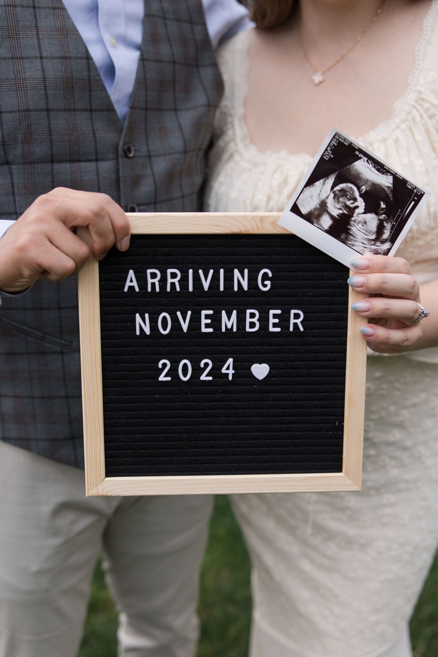 Letterboard announcing November 2024 arrival date with ultrasound photo and heart detail.