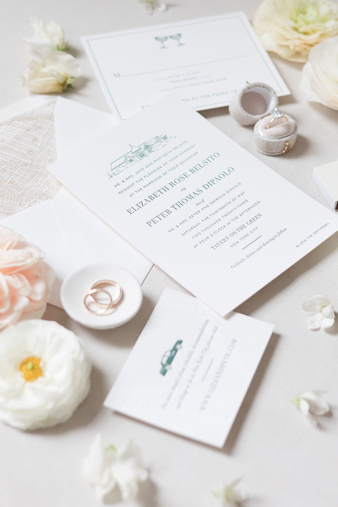 Elegant wedding invitation suite with green accents and floral decorations.