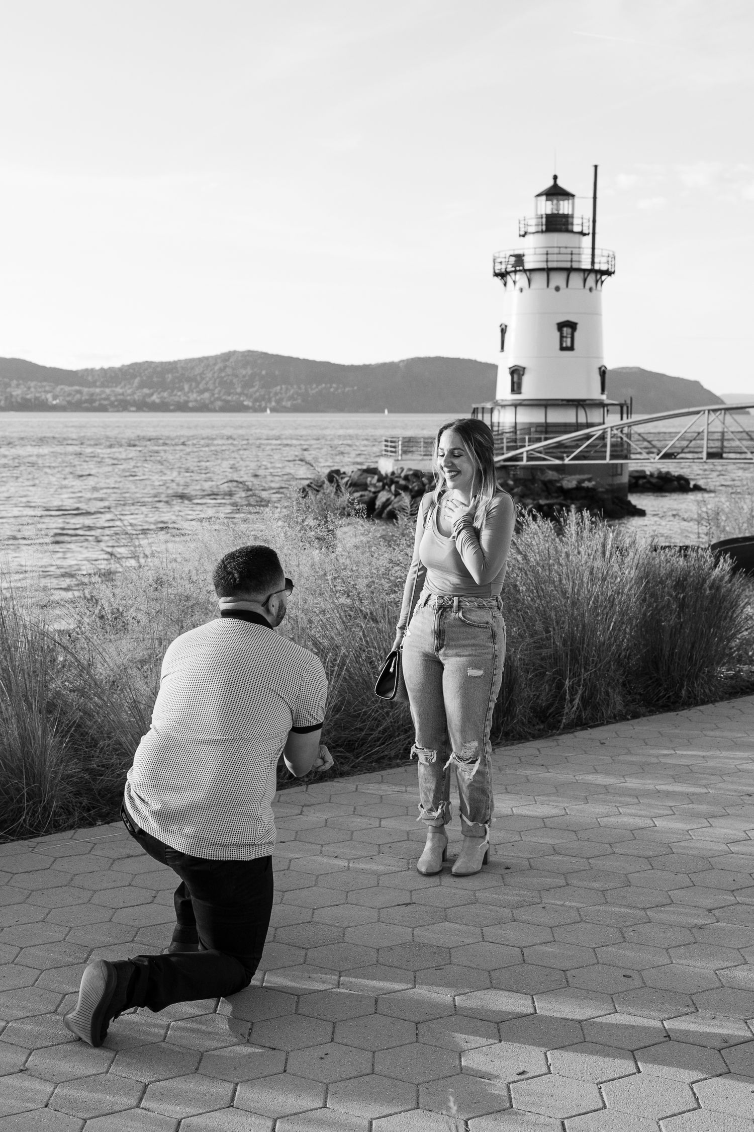 A sequence of photos showing someone taking pictures in front of a lighthouse on a coastal path during daytime.