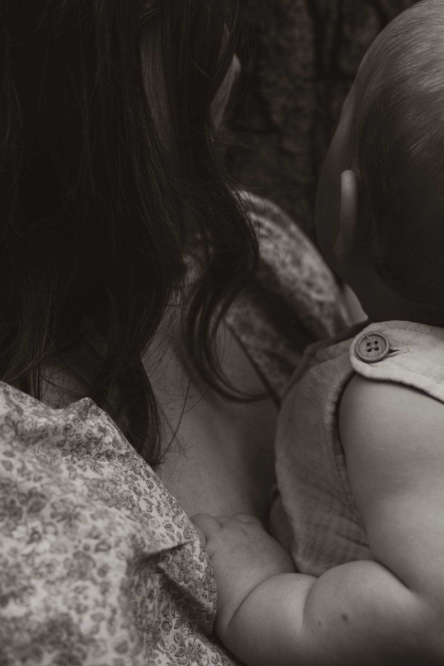 Intimate black and white close-up photograph showing delicate details of fabric and skin.