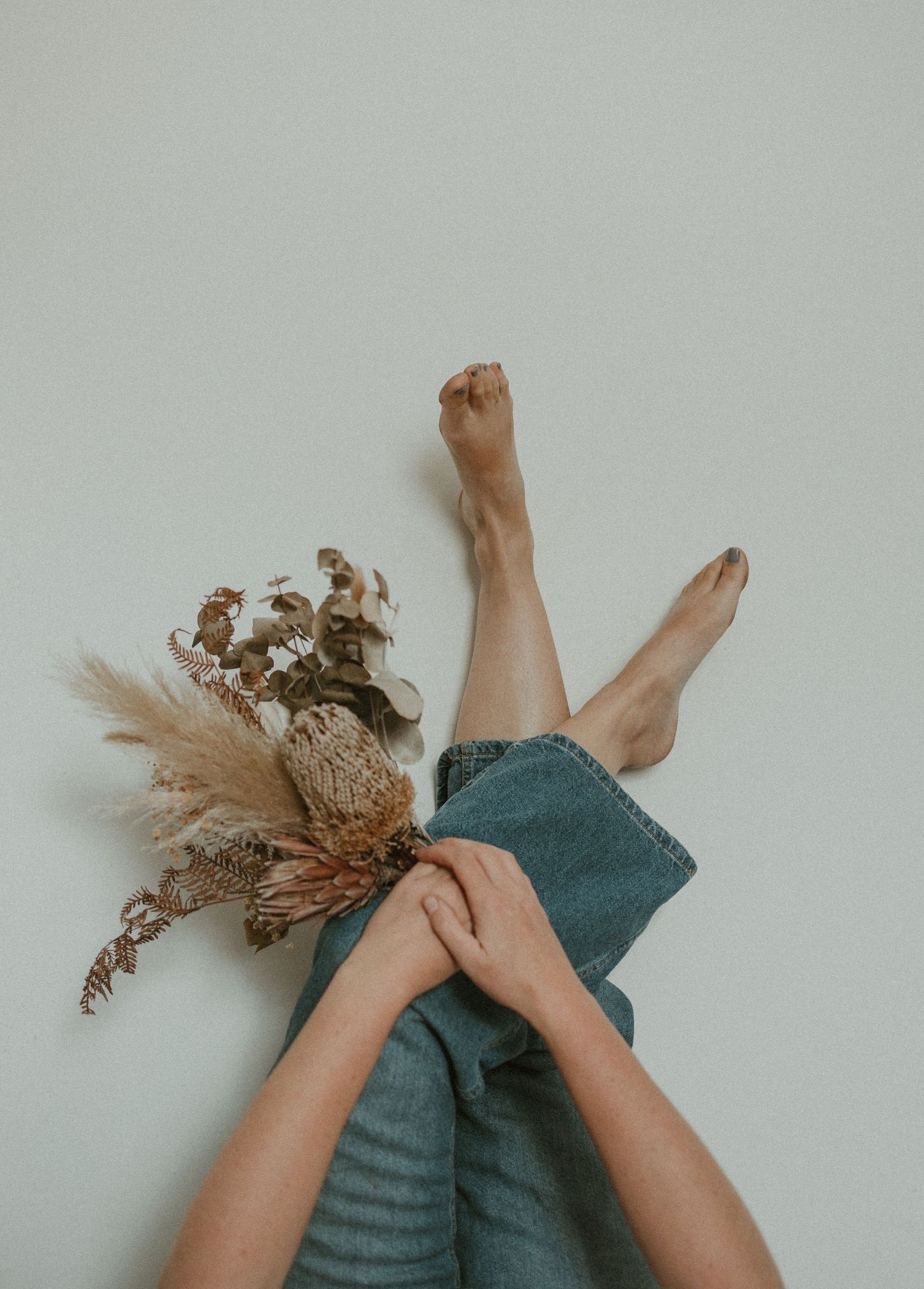 Bare feet resting on white wall. Kangaroo Island.