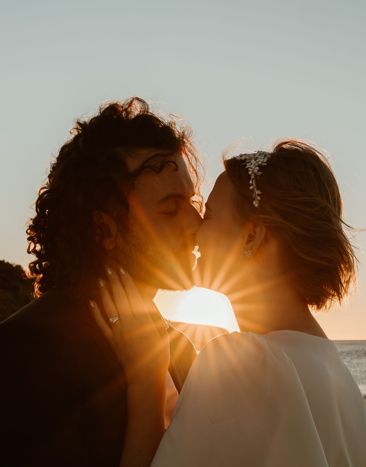 Romantic sunset silhouette with sun rays creating dramatic backlighting.