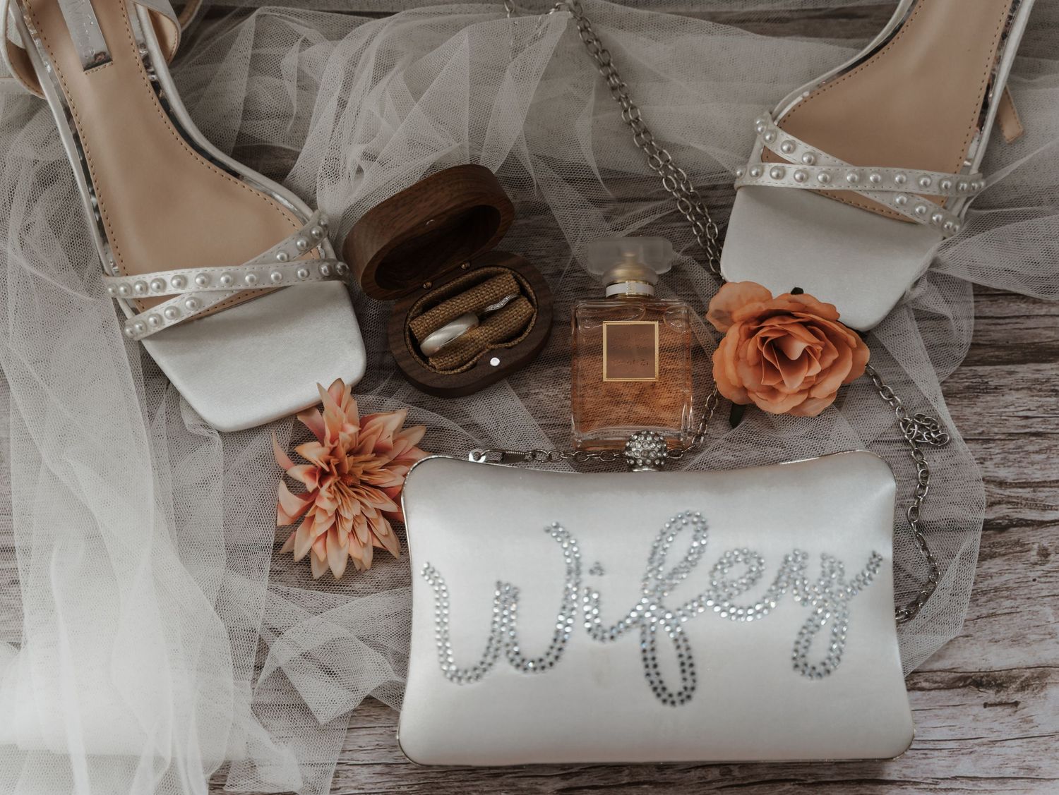 Brides details including wedding shoes, wedding rings and perfume, captured at Lazaat Hotel in Cottingham by a candid wedding photographer