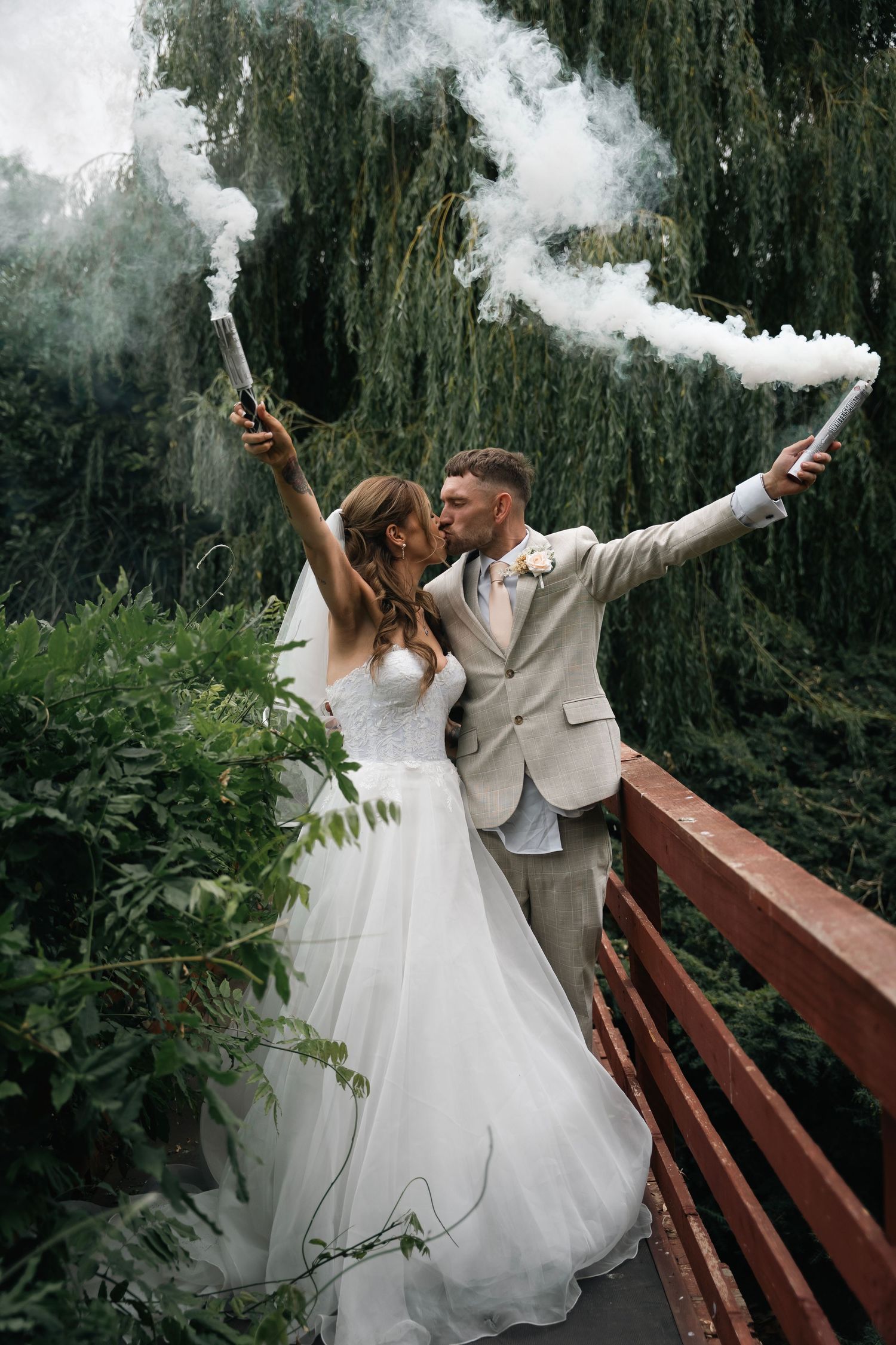 Image of a wedding couple with smoke grenades at lazaat hotel, hull, captured by an East Yorkshire wedding photographer