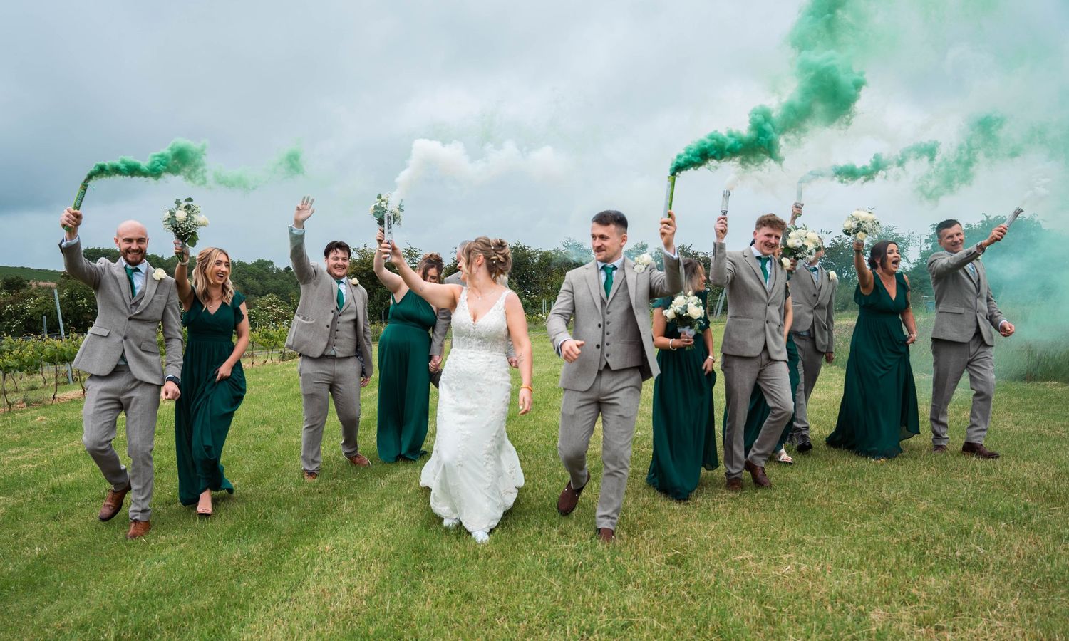 Bride and groom with coloured smoke grenades  at Little Wold vineyard, captured by a candid wedding photographer in East Yorkshire