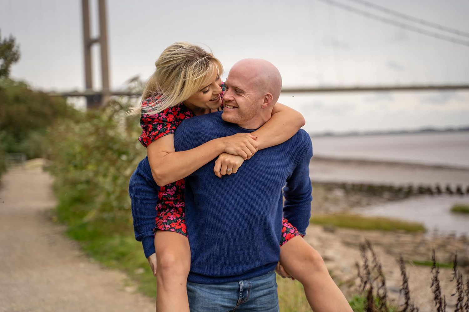 piggyback laughs and smiling during their engagement shoot, taken by a Yorkshire wedding photographer in Hull
