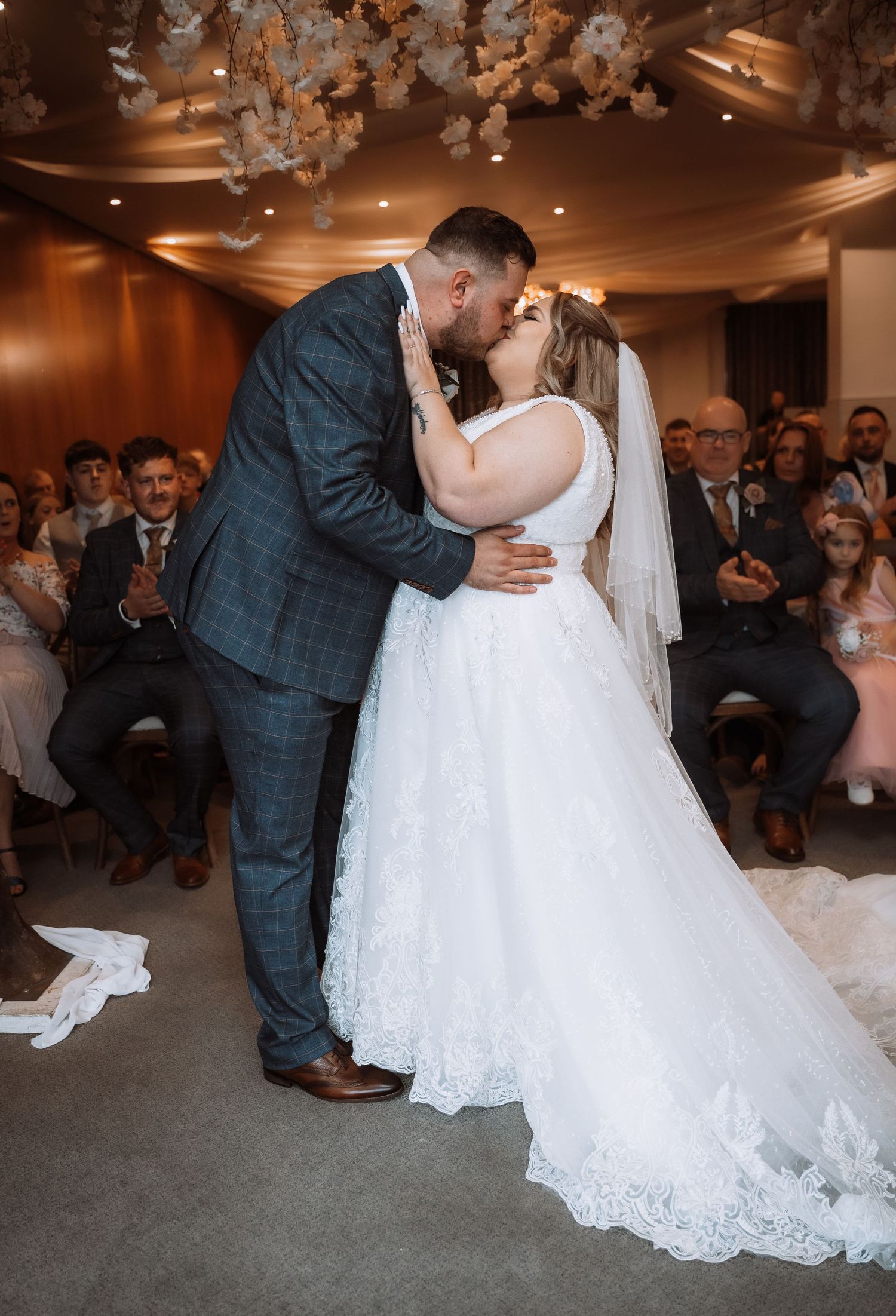 Bride and grooms first kiss as Mr and Mrs at Lazaat Hotel in Hull, captured by a natural wedding photographer in East Yorkshire