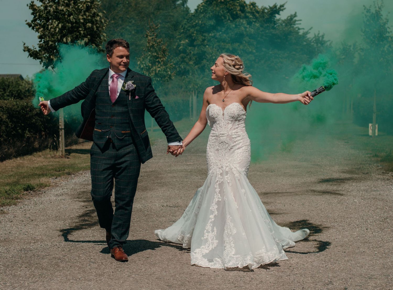 Bride and groom with coloured smoke grenades at The Beverley barn, captured by a documentary wedding Photographer in Beverley
