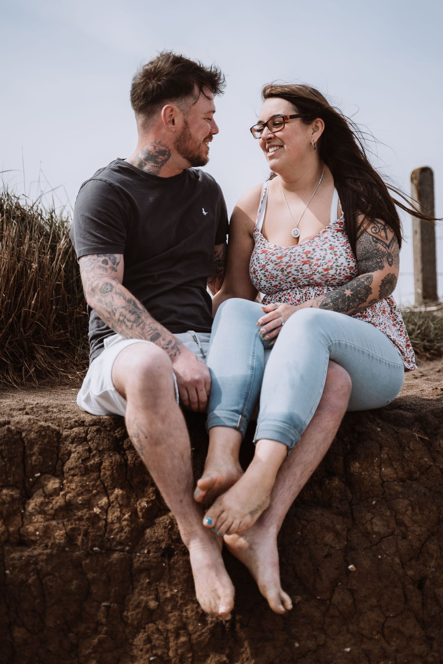 Couple sat smiling during their engagement shoot, taken by a Yorkshire wedding photographer in Hull