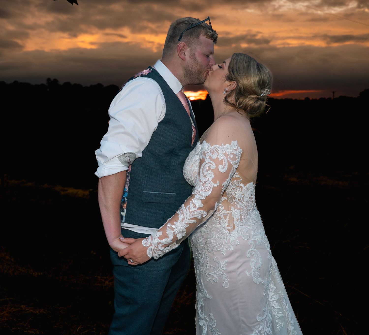 Bride and groom sharing a kiss under the sunset, captured by a wedding photographer in Hull