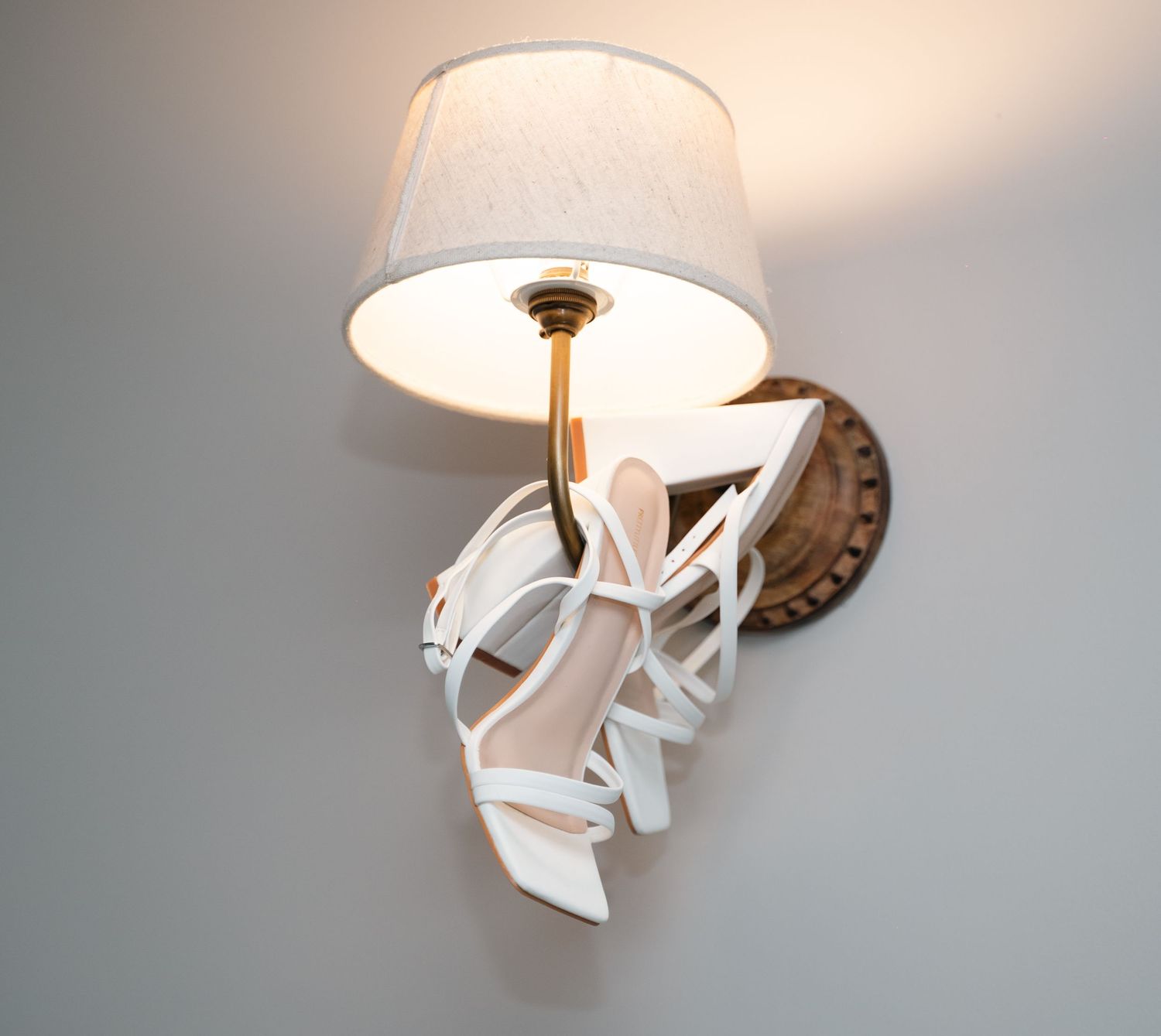 wedding Shoes hung on a lamp at the Triton inn, Hull captured by a documentary style wedding photographer.