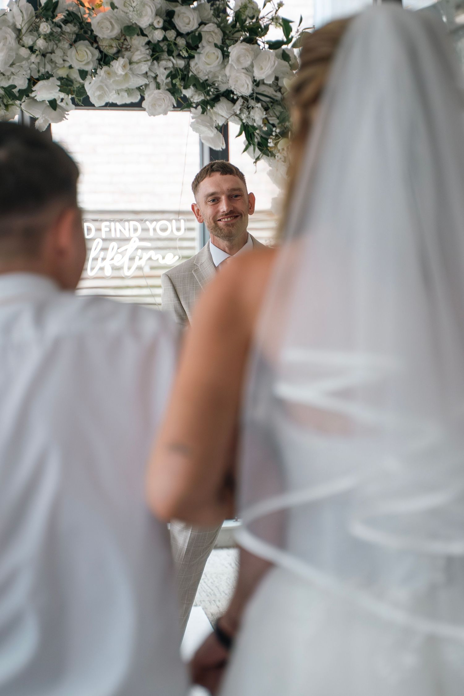 Groom seeing his bride for the first time down the aisle at Lazaat Hotel in Cottingham, Captured by a candid wedding photographer in Hull