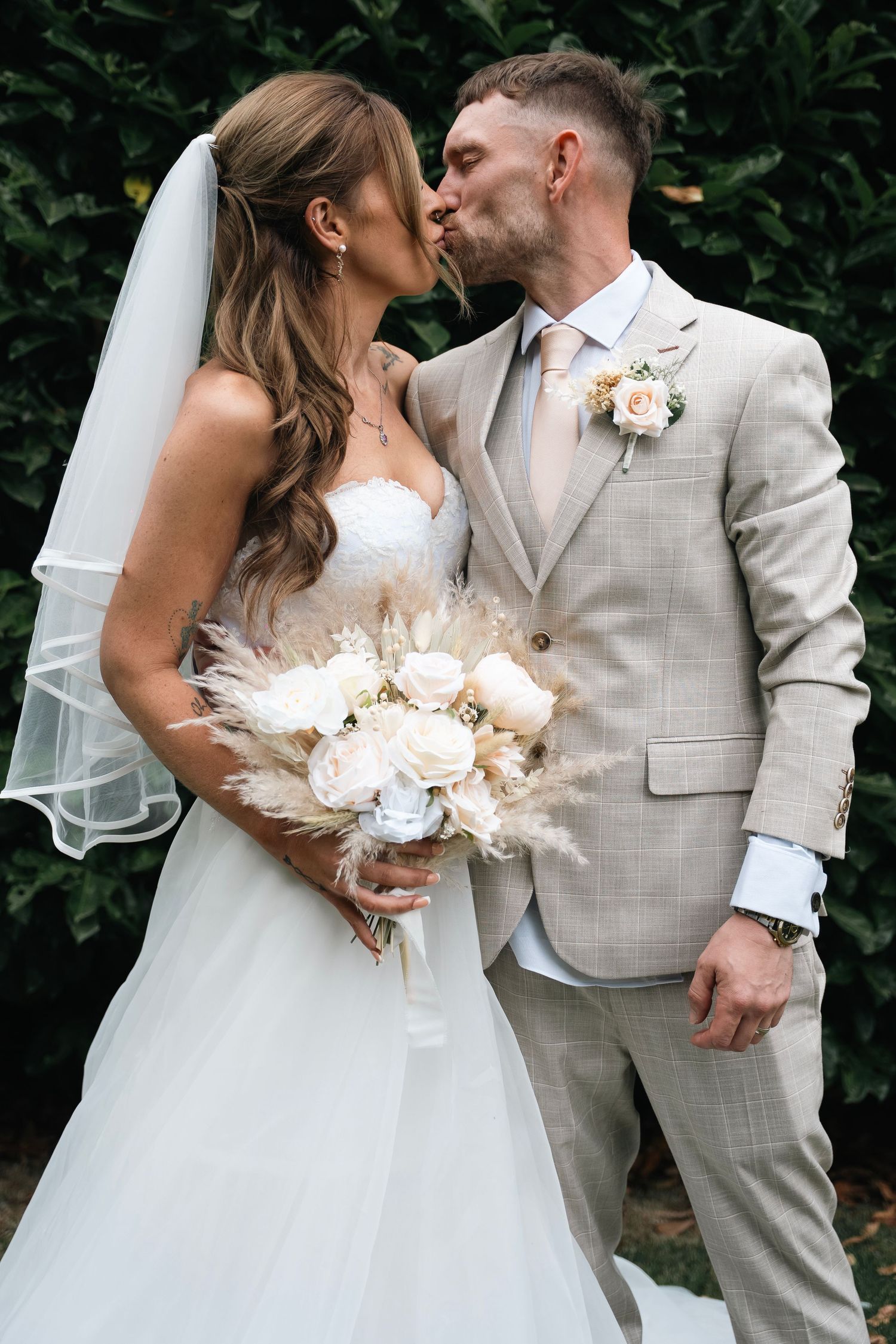Bride and groom kissing taken at Lazaat Hotel in Cottingham, captured by a candid wedding photographer in East Yorkshire.