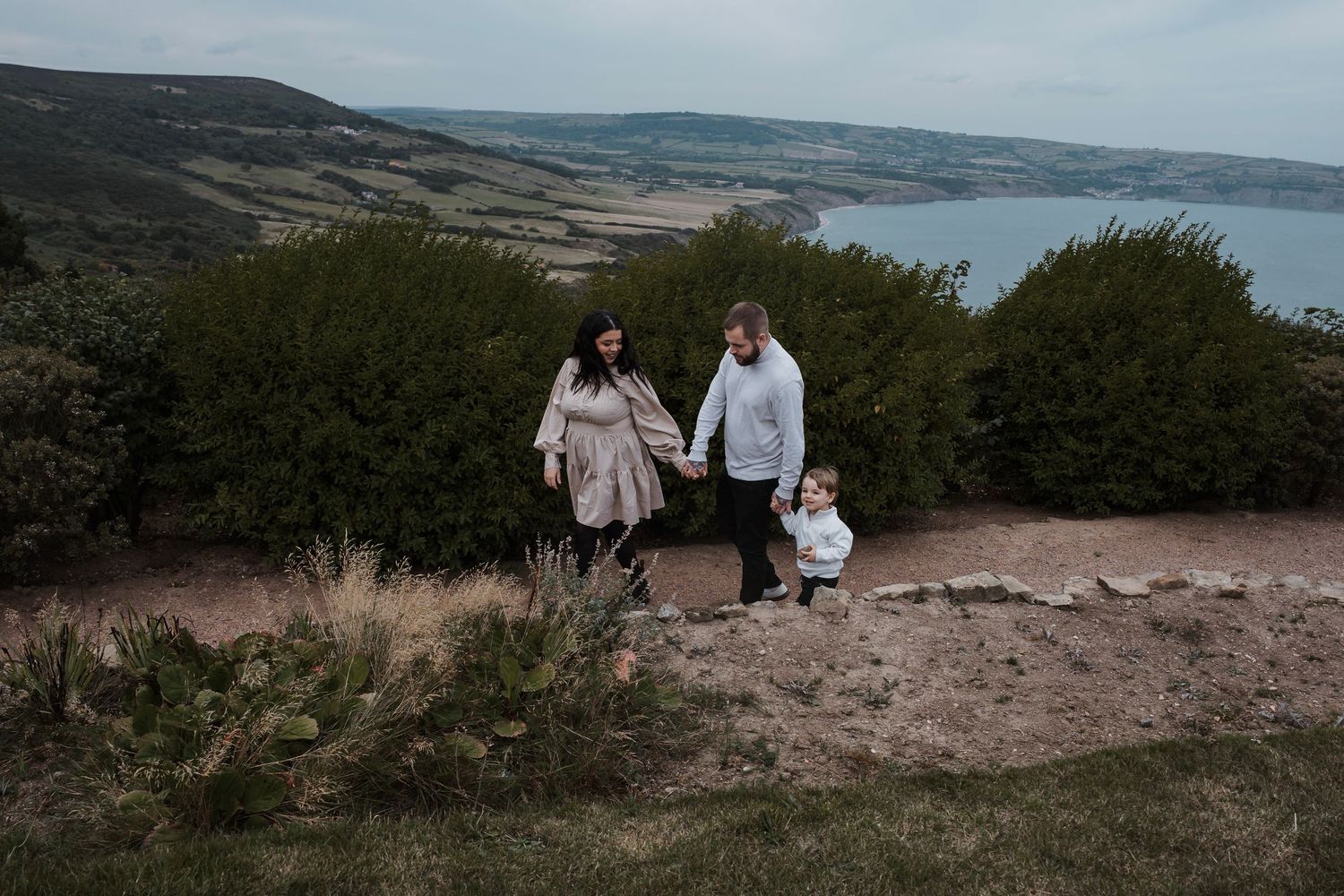 Family walking together during their engagement shoot, taken by a Yorkshire wedding photographer at Grand villa heights
