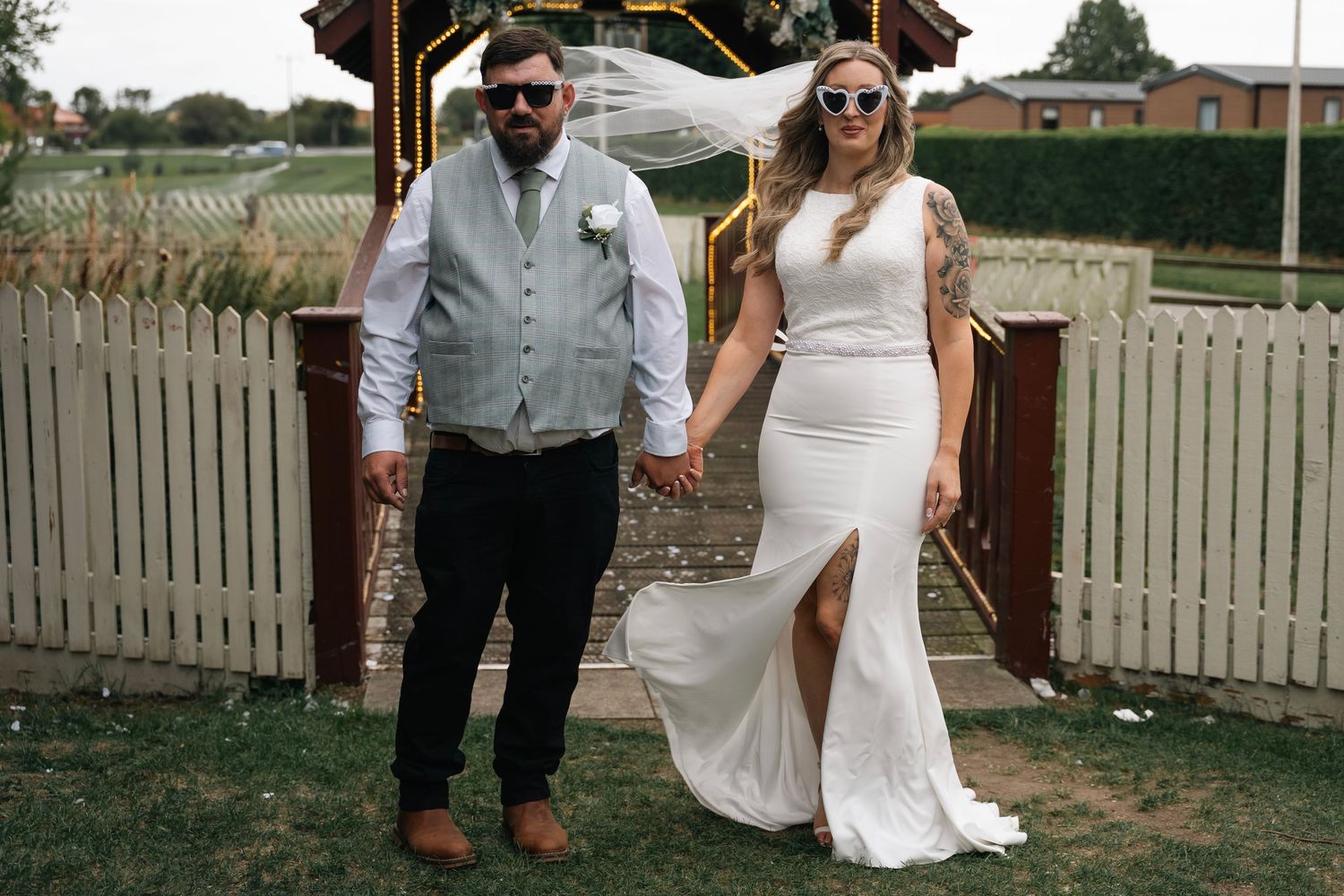 Couple posing with glasses during their wedding at the gardeners country inn