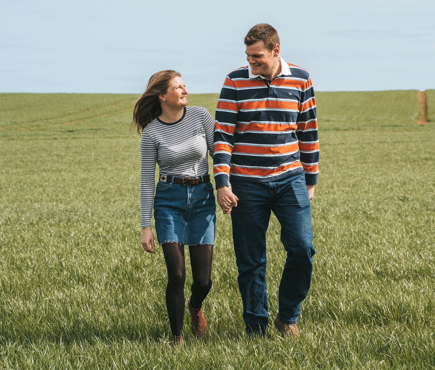 Couple holding hands and smiling during their engagement shoot, taken by a Yorkshire wedding photographer in Hull