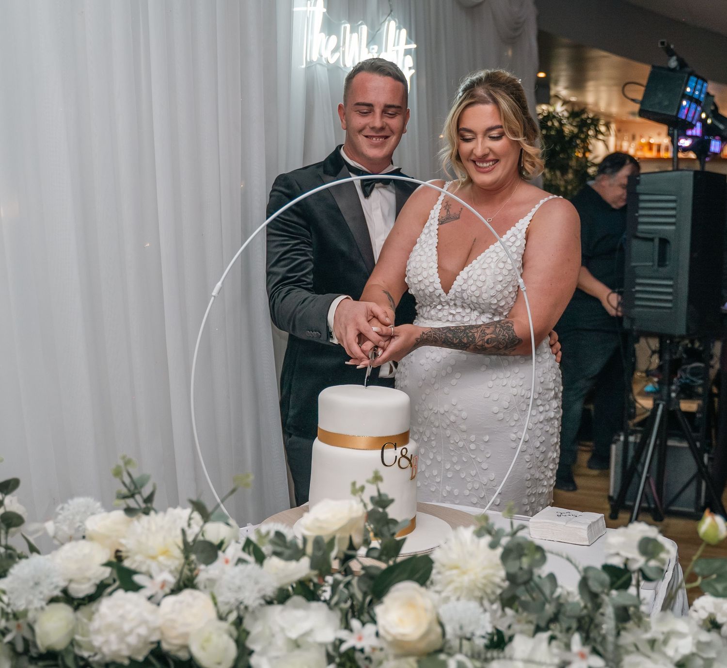 Bride and groom cutting their cake at Lazaat Hotel, Cottingham, captured by a candid East Yorkshire wedding Photographer