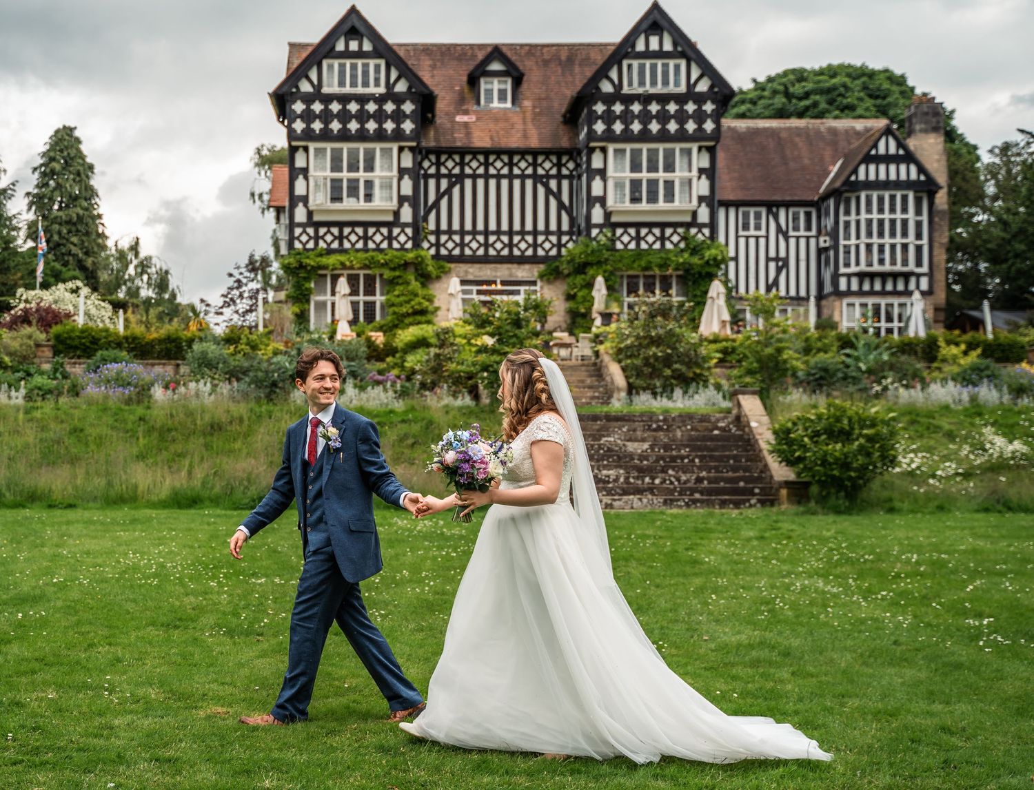 Bride and groom walking together at the Highfield house in Driffield, captured by a documentary wedding photographer in East Yorkshire.