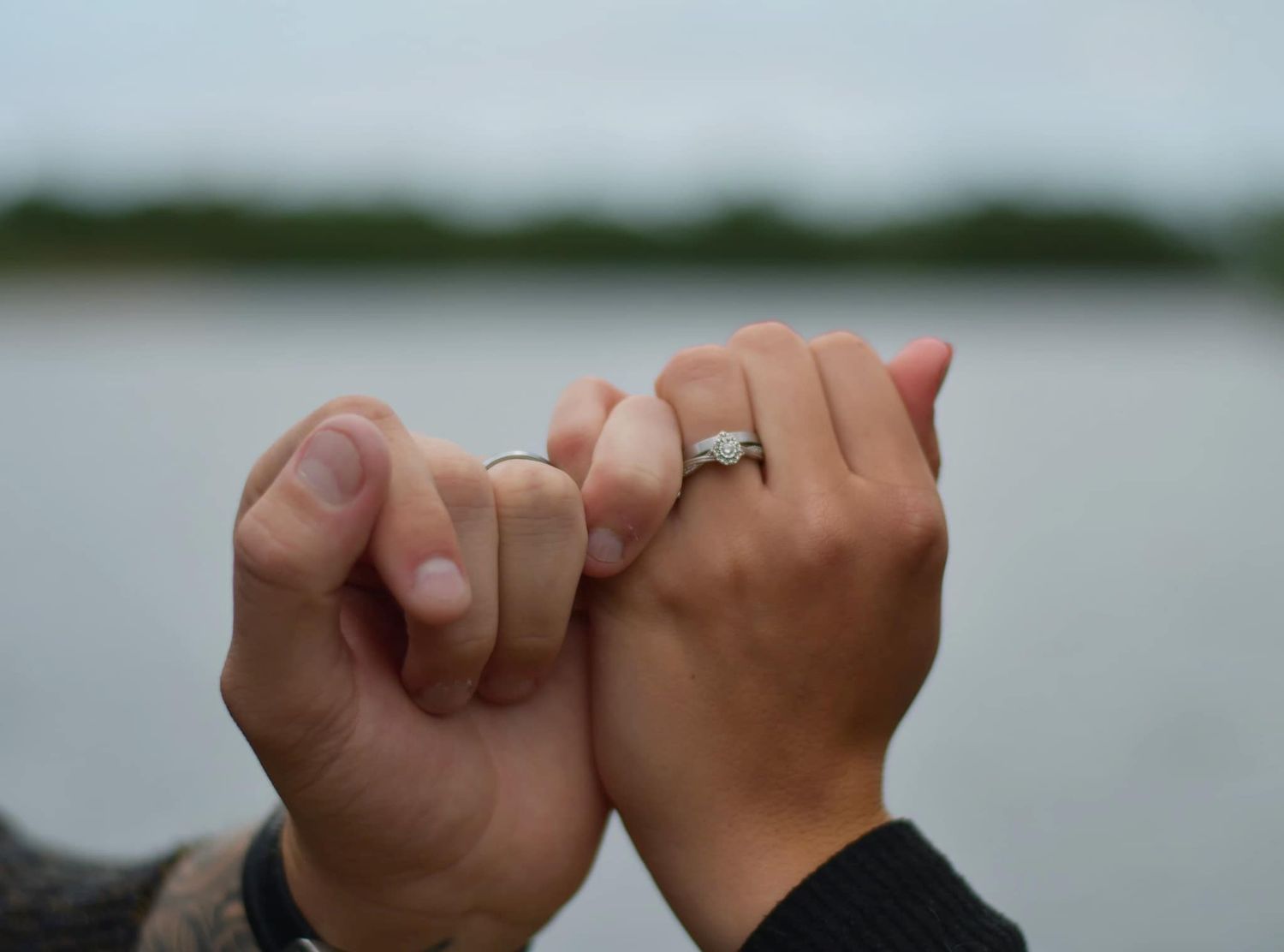 Couple holding hands showing off their engagement ring during their engagement shoot, taken by a Yorkshire wedding photographer in Hull