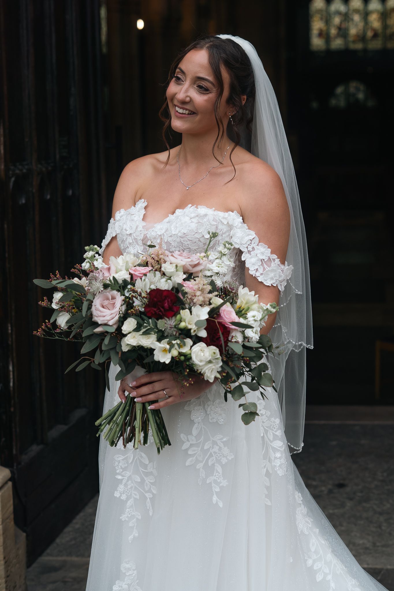 Bride holding her wedding bouquet outside St Marys church Beverley
