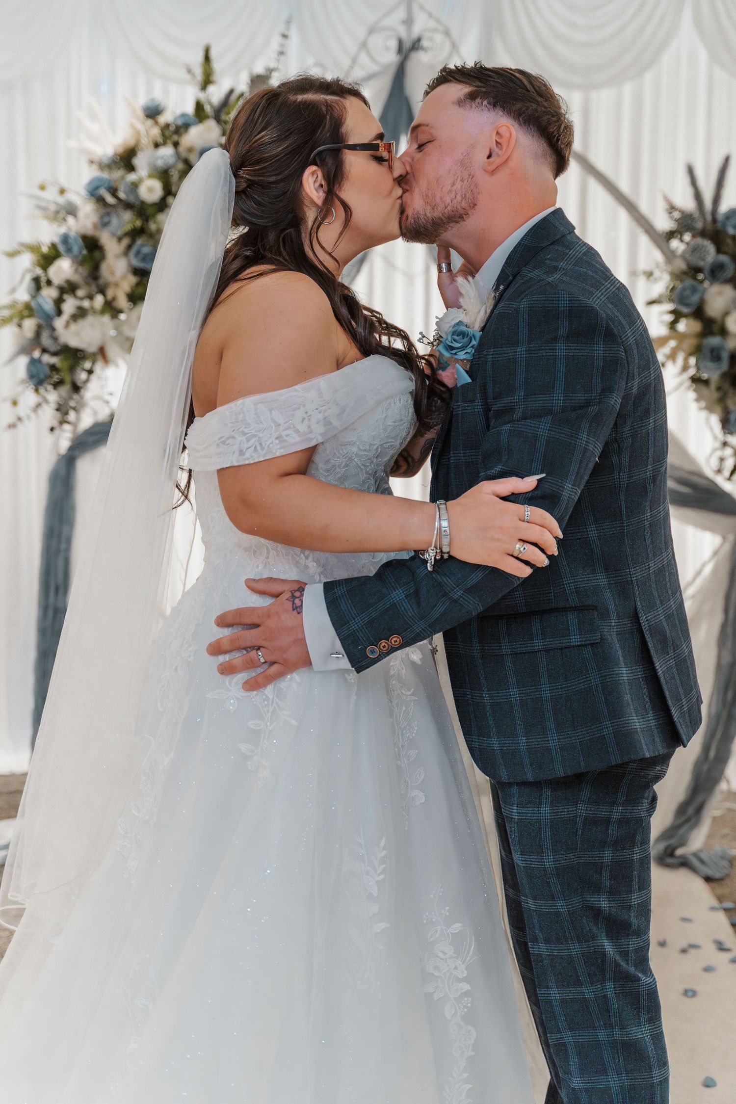 Bride and grooms first kiss during their wedding ceremony at The gardeners country inn, captured by natural wedding photographer.