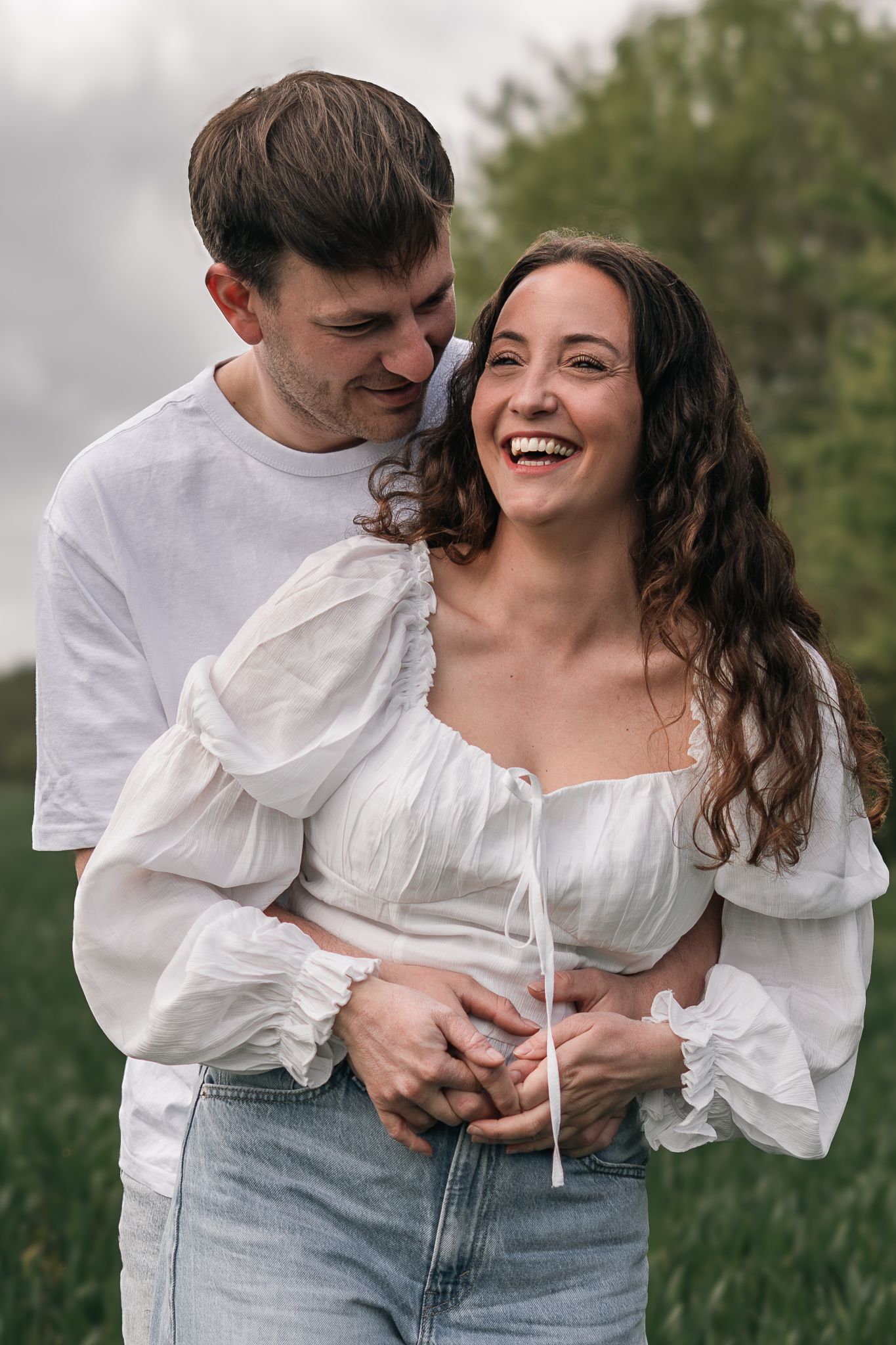 couple laughing and having fun during their engagement shoot, taken by a Yorkshire wedding photographer In east Yorkshire