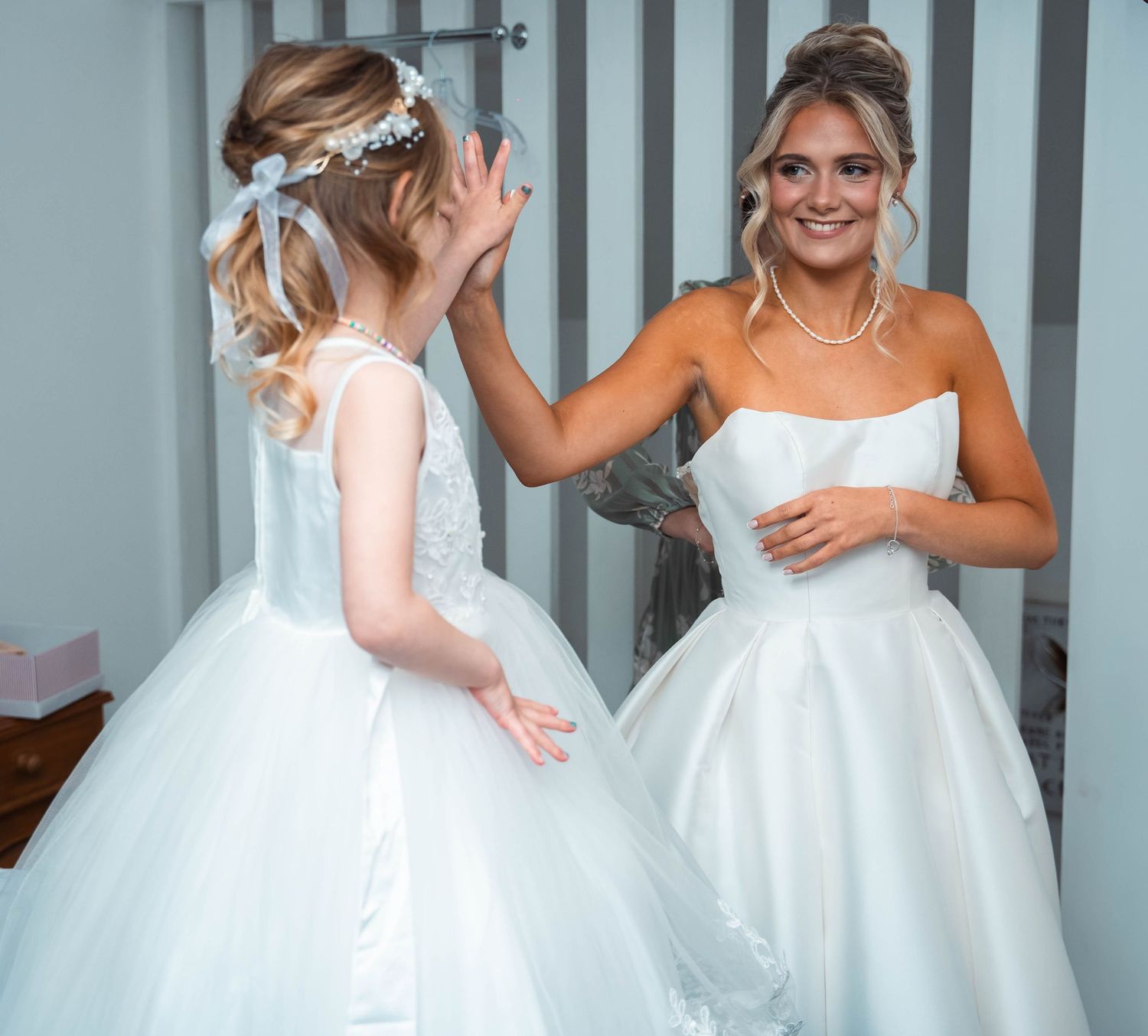 The bride & her daughter sharing a high five during the morning of her wedding at The gardeners country inn, by Emily bailey photography