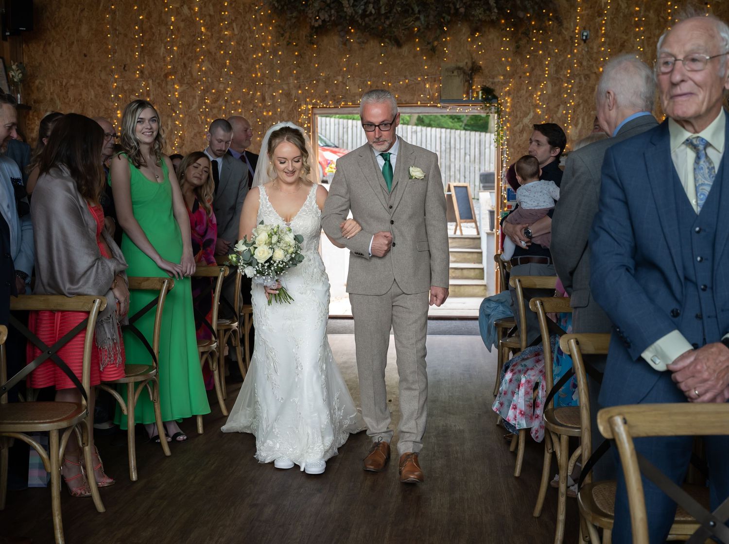 The bride and her dad walking down the aisle at Little Wold Vineyard, captured by Hull wedding Photographer