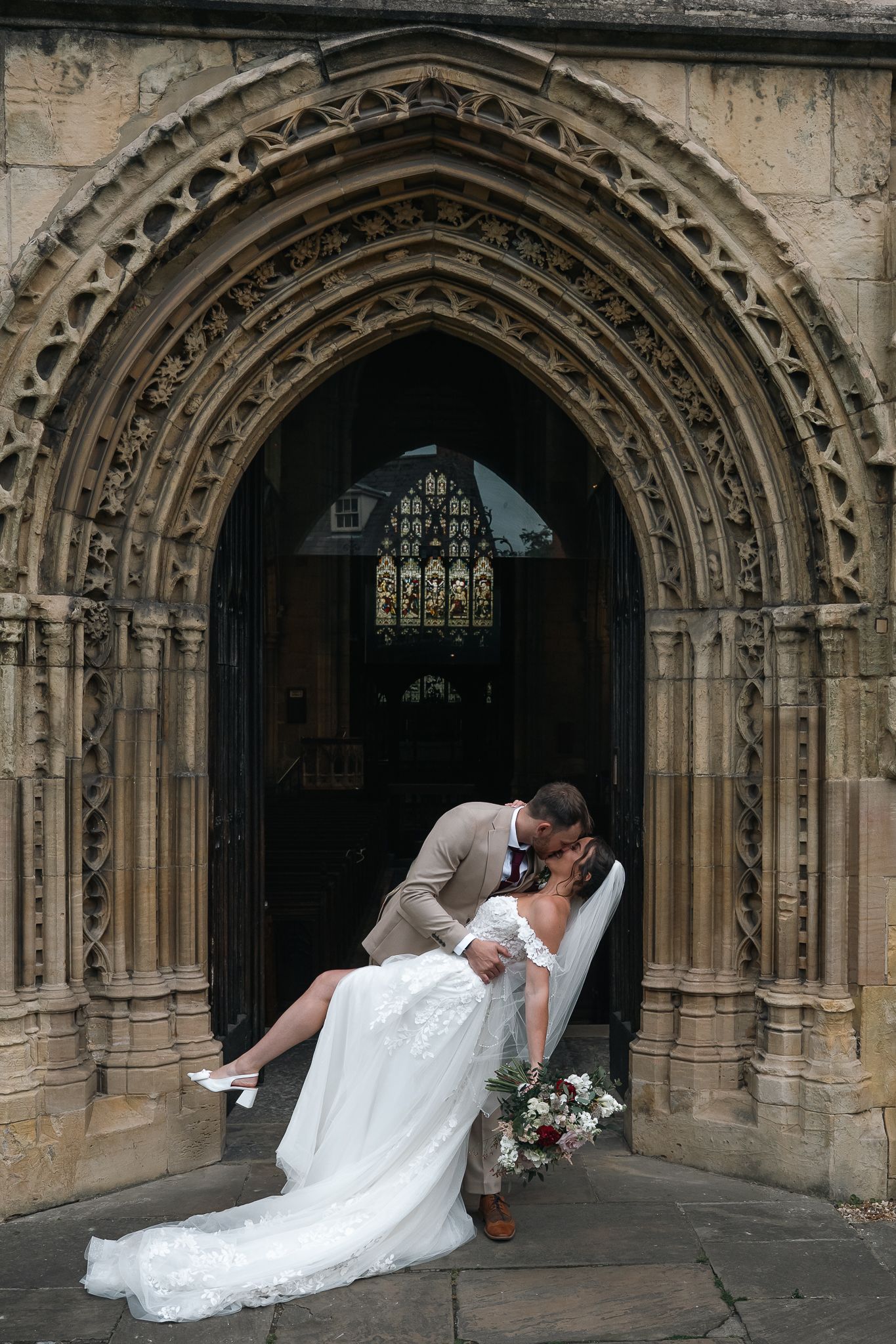 Bride and groom share a dip kiss outside of St Marys church, Beverley after their ceremony.