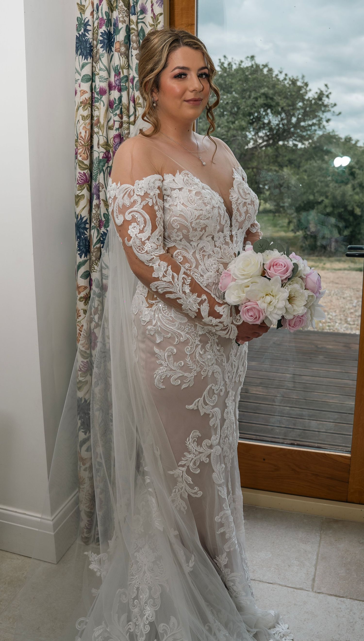 Bride stood in front of the window taken by a Yorkshire wedding Photographer