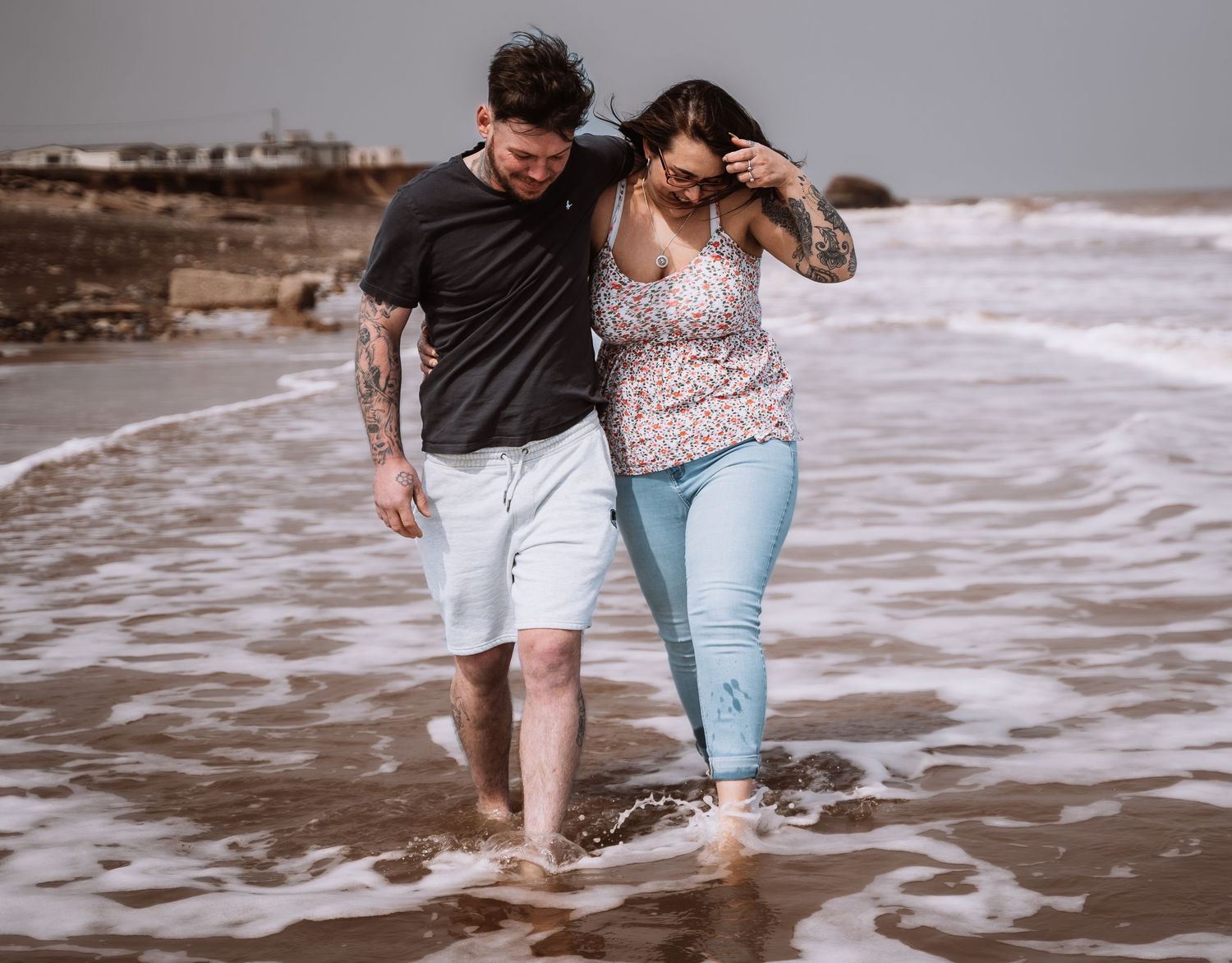 Couple walking and smiling during their engagement shoot, taken by a Yorkshire wedding photographer in Hull