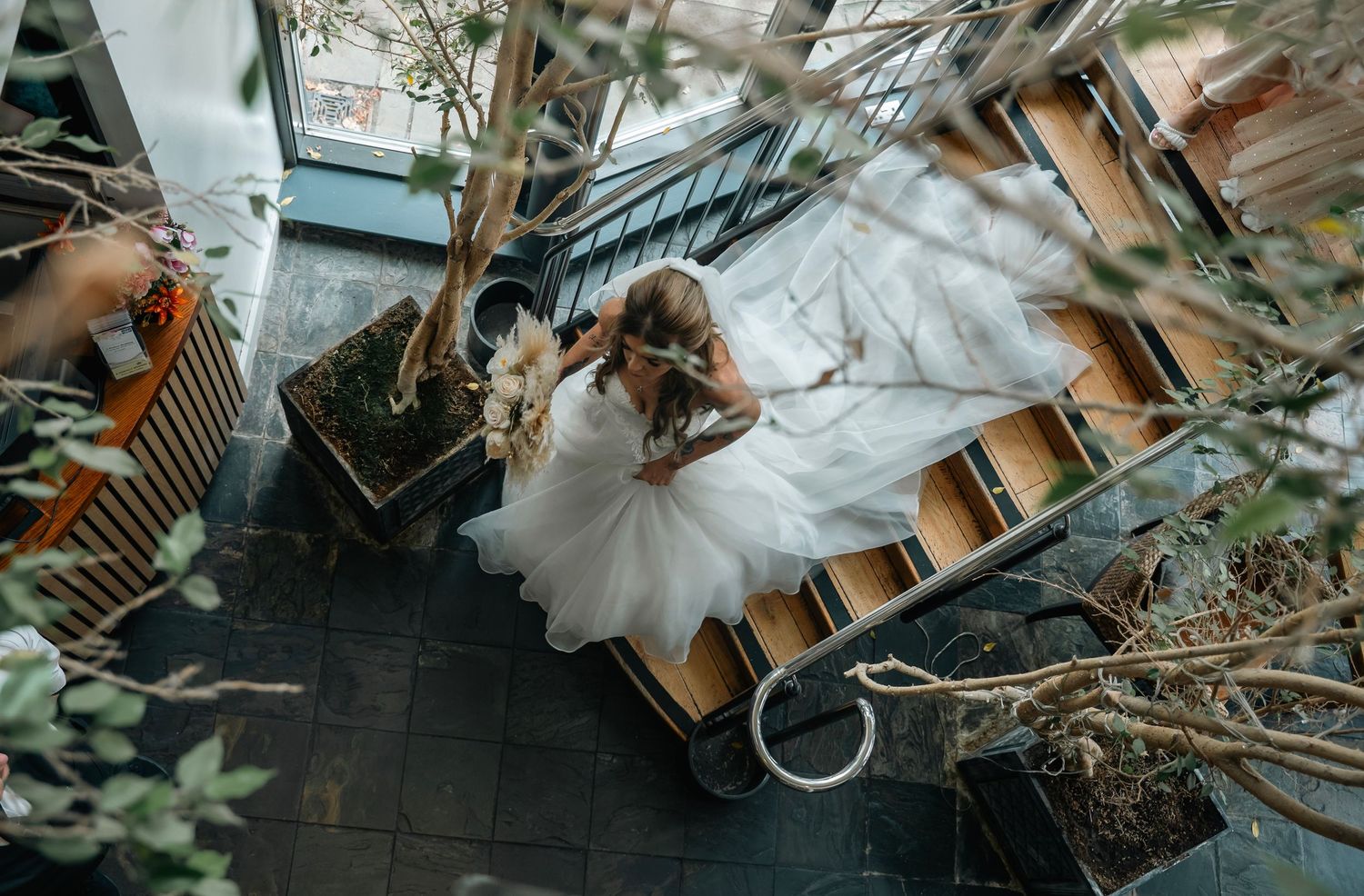 Bride walking downstair at Lazaat Hotel, Cottingham, captured by an East Yorkshire wedding photographer