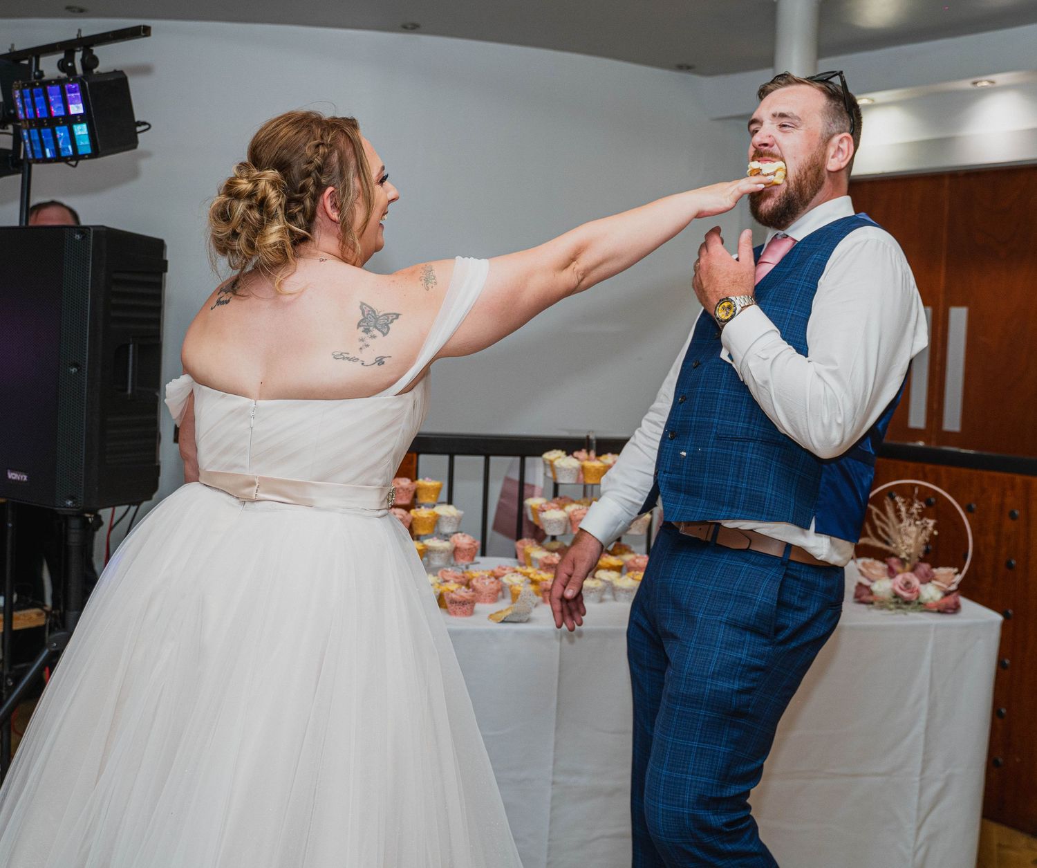 Bride feeding the groom cake at Lazaat Hotel in Cottingham, captured by a candid Hull wedding photographer