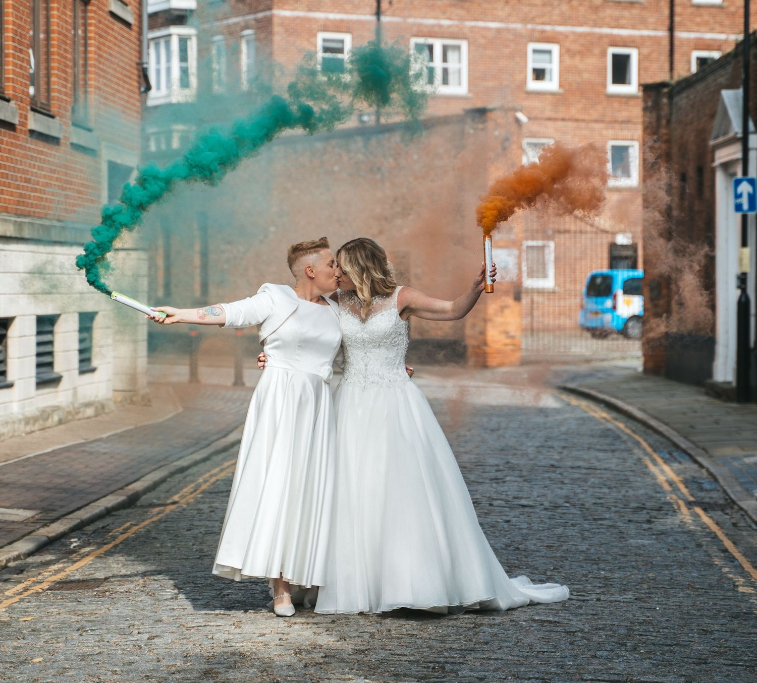 Bride and bride with coloured smoke grenades at The guildhall in Hull, captured by a candid wedding photographer