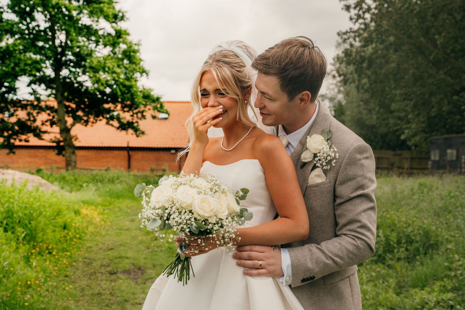 Bride and groom laughing together at the gardeners country inn, captured by Yorkshire wedding photographer