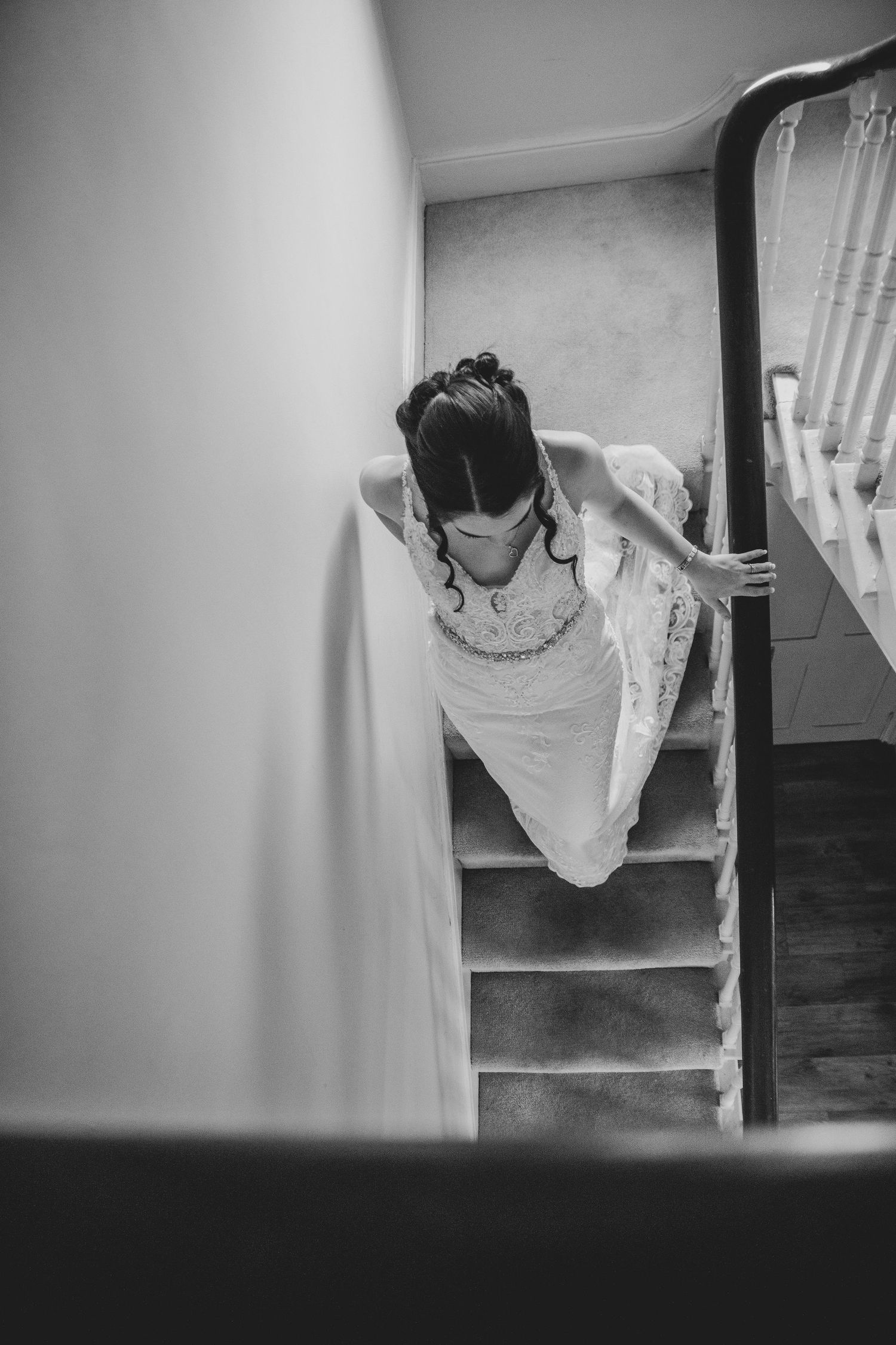 Bride walking down the stairs to her ceremony at Dunedin country house, captured by a Wedding photographer in Yorkshire