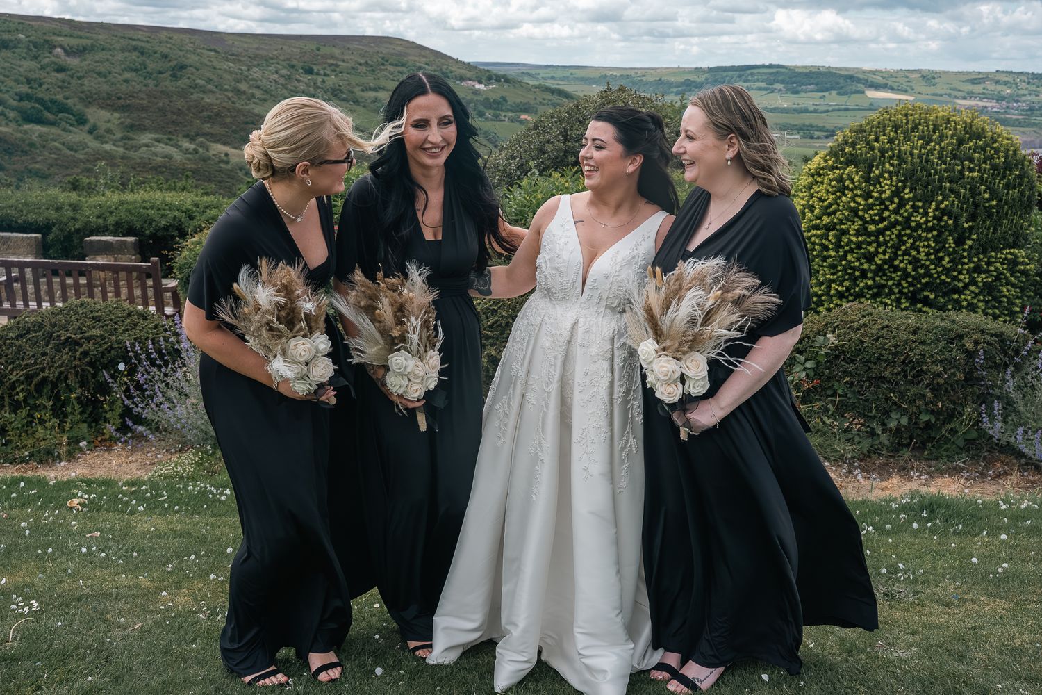 Bride with her bridesmaids overlooking the Yorkshire countryside at Grand Villa Heights.