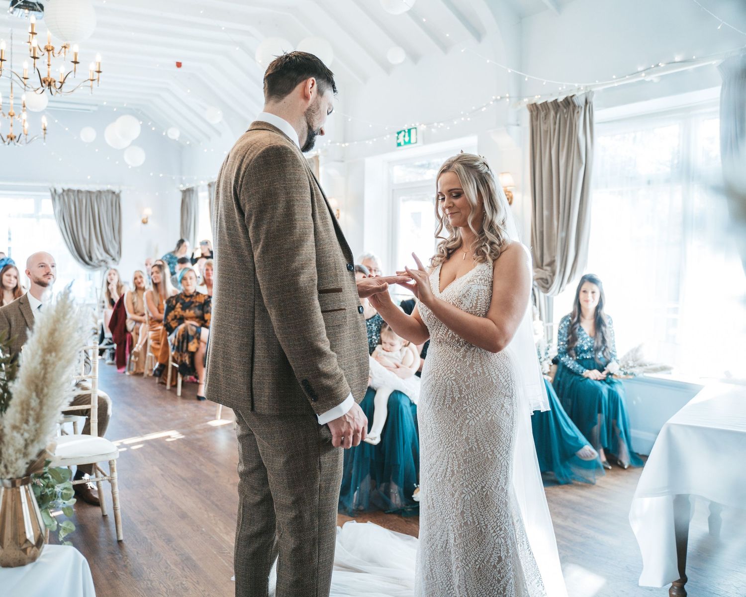Bride and groom exchanging rings at The Triton Inn, brough, captured by a candid wedding photographer in Yorkshire