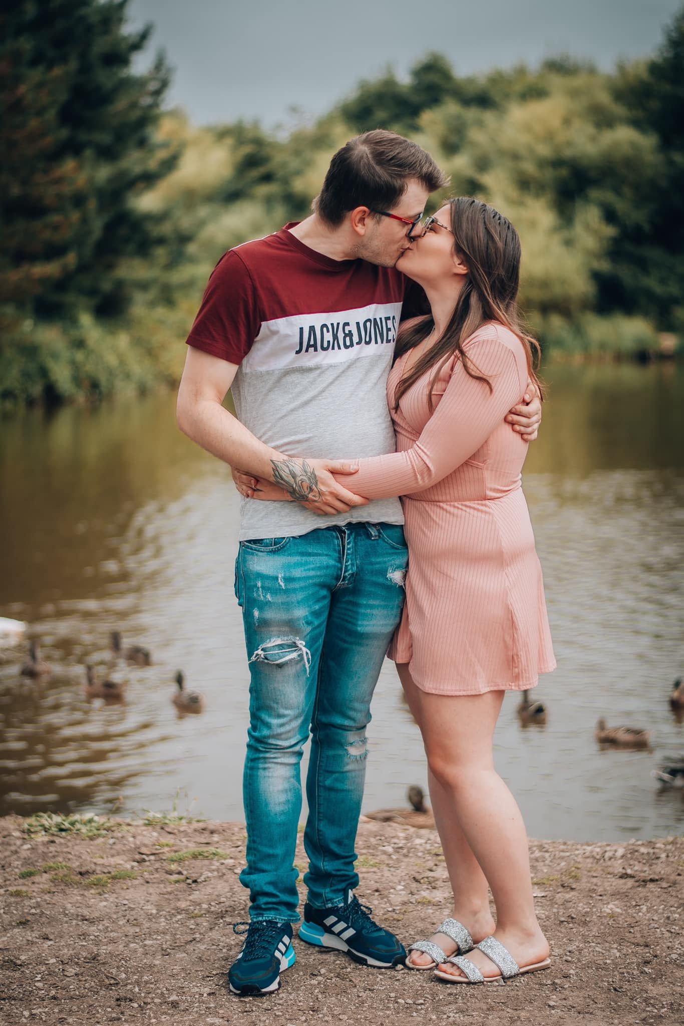Couple holding hands and kissing during their engagement shoot, taken by a Yorkshire wedding photographer in Hull